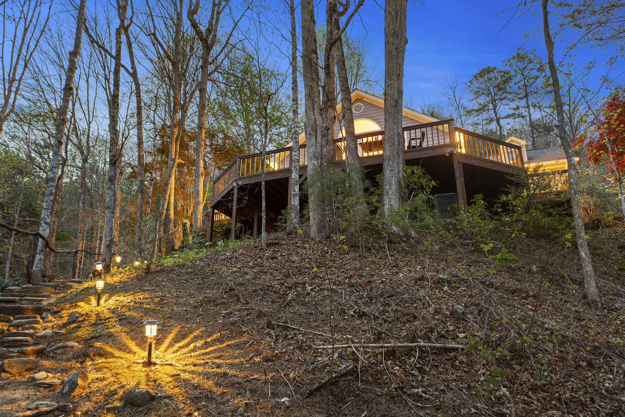 Outdoor Retreat: Discover your private haven with stunning forest views and inviting deck lights!