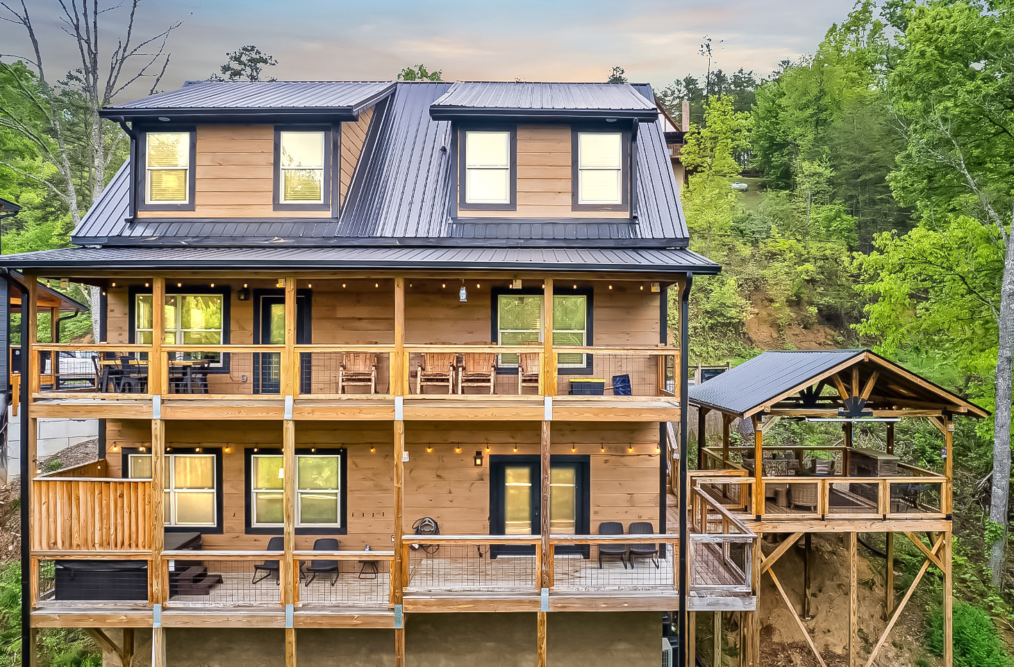 Drone photo capturing the expansive decks and the covered pavilion. The pavilion is 16 by 20 and dwarfs in comparison to the lodge. Plenty of space for visiting on the pavilion.