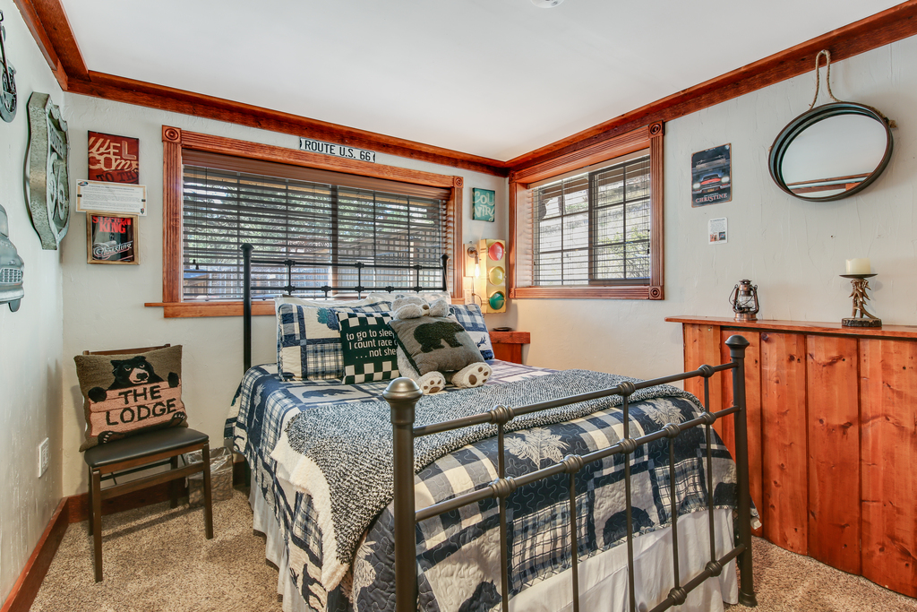 Route 66‑themed bedroom with comfortable bedding and warm lighting.
