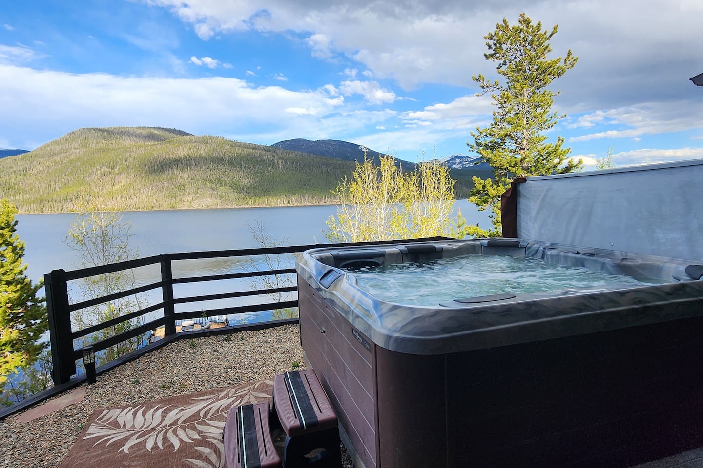 Hot Tub sits on upper rock patio space near the house