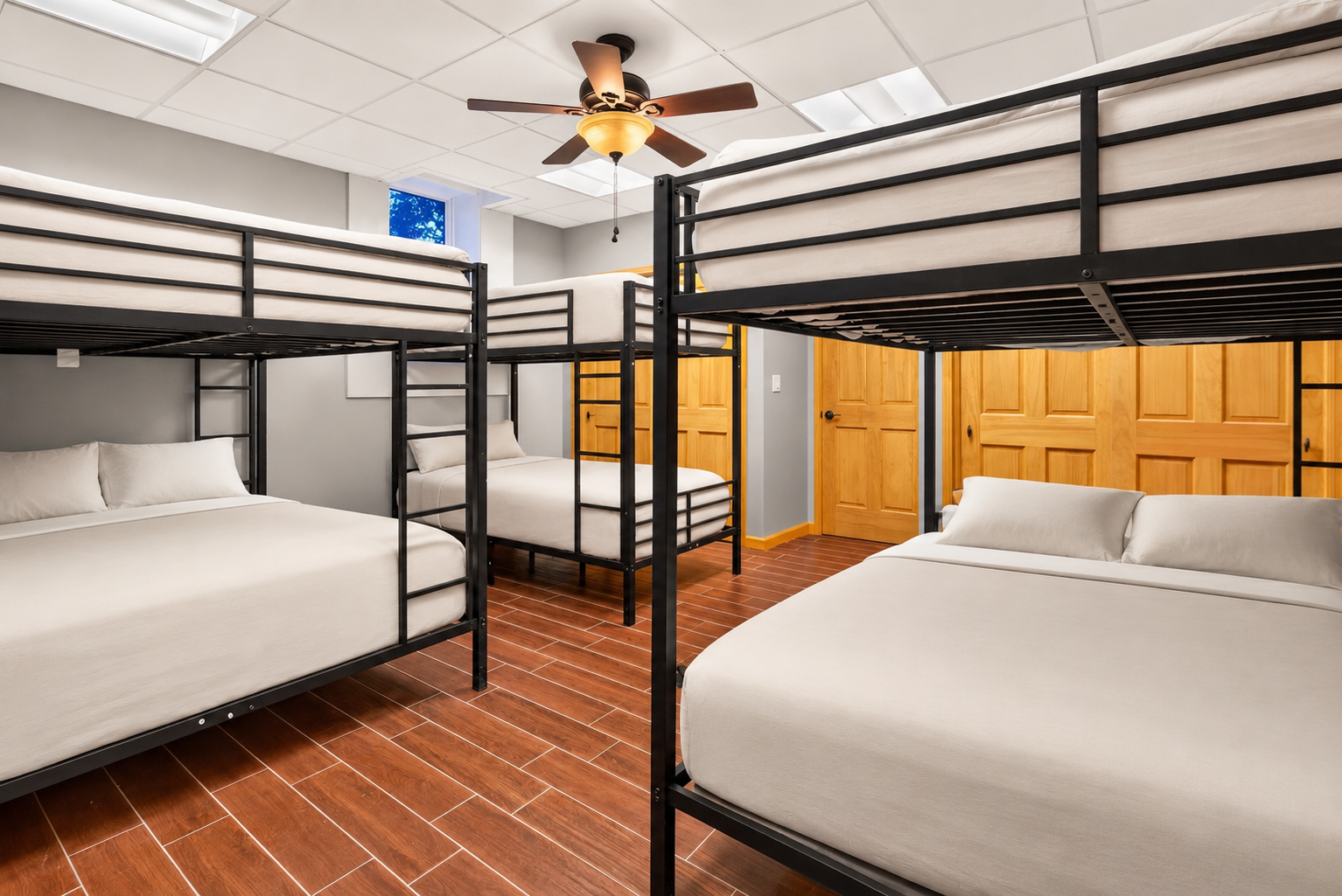 Bunk room with multiple metal-framed beds
