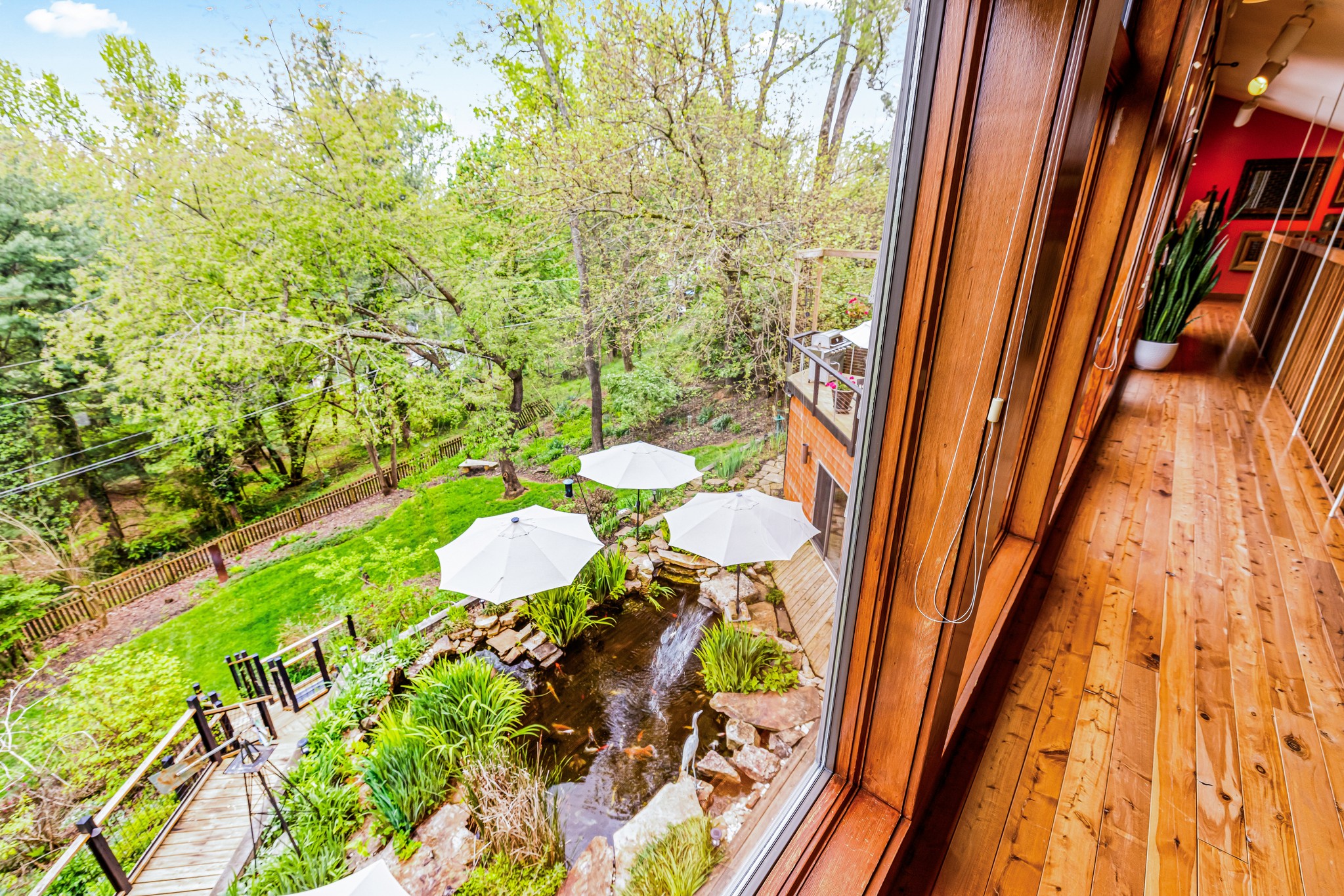 The 3rd floor reading nook on the Catwalk overlooks the Koi Pond and peaceful backyard gardens. Deer wander by on the lower lawn, clouds float by, birds fly at eye level. Houseplants hide this nook from the main floor - no one will even know you're hiding!