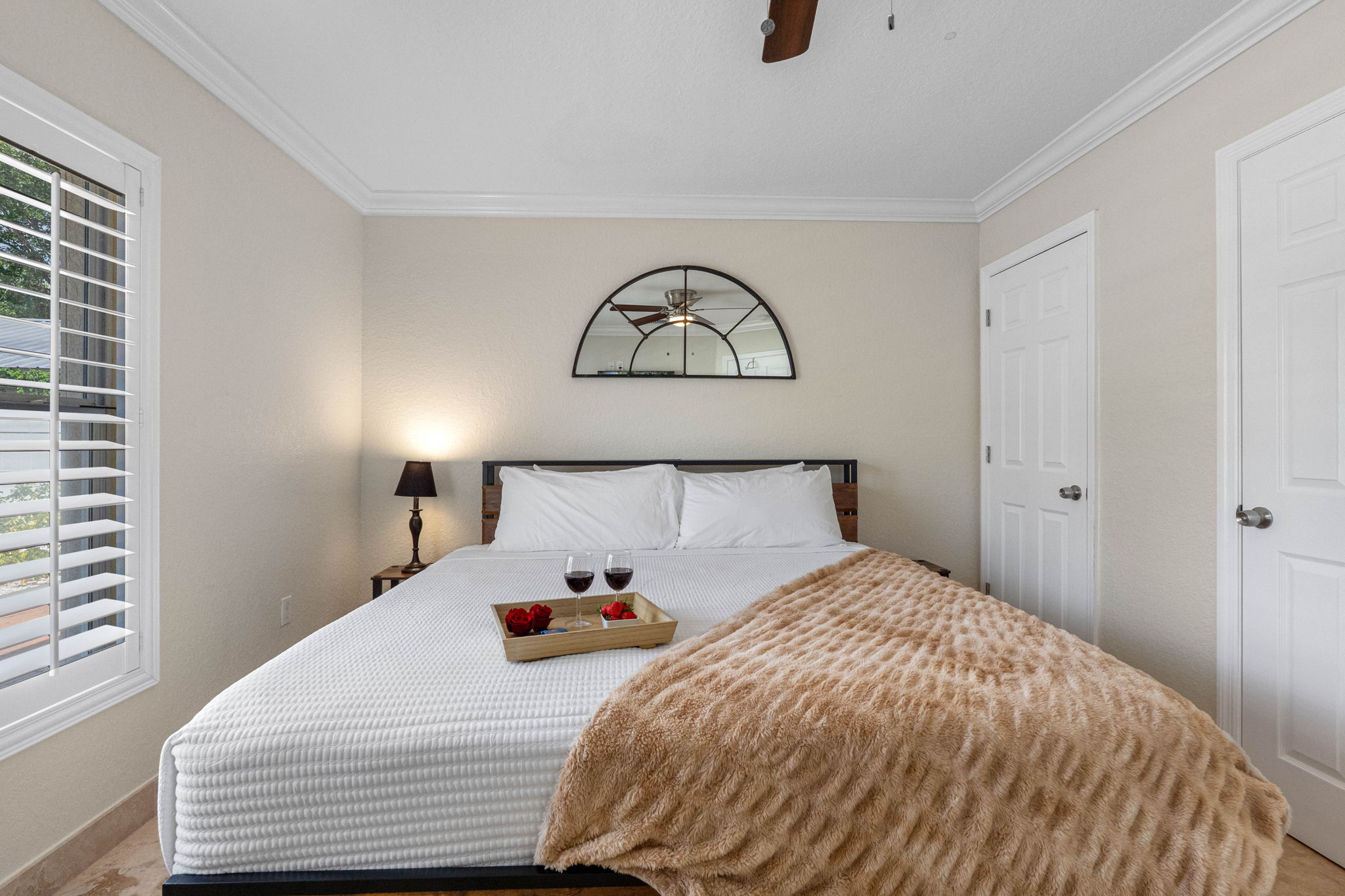 The wood-accented bed frame and earthy throw add rustic charm to this otherwise sleek and modern bedroom.