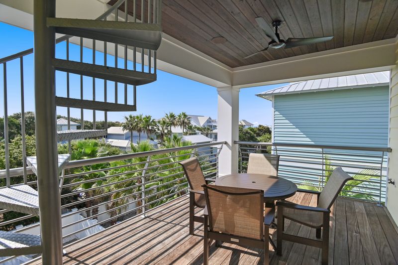 Third-floor balcony with spiral staircase access to the rooftop.