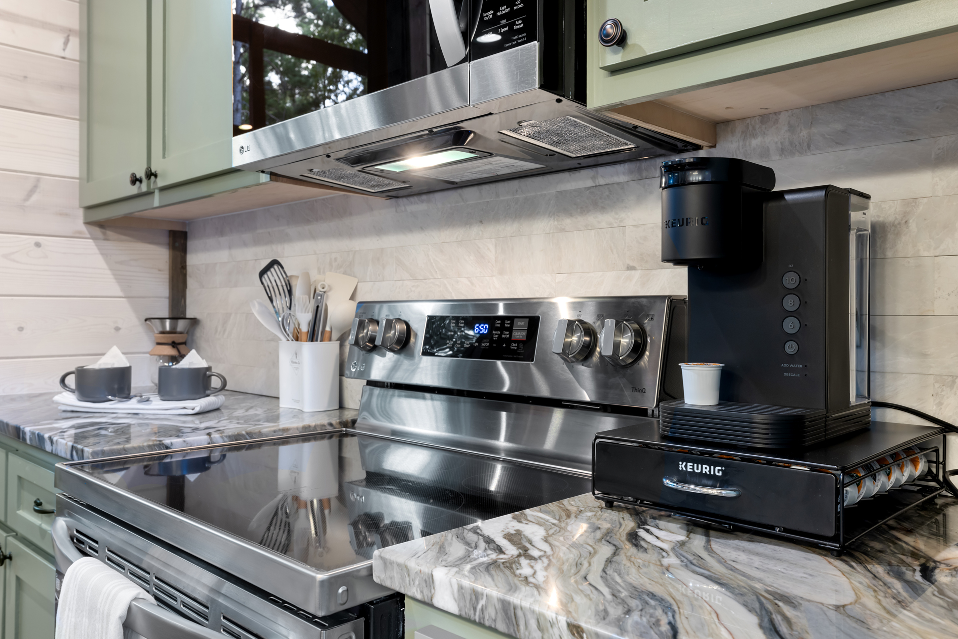 Well-appointed kitchen featuring oven, stove, and coffee maker, fully stocked for effortless cooking and your daily coffee routine.
