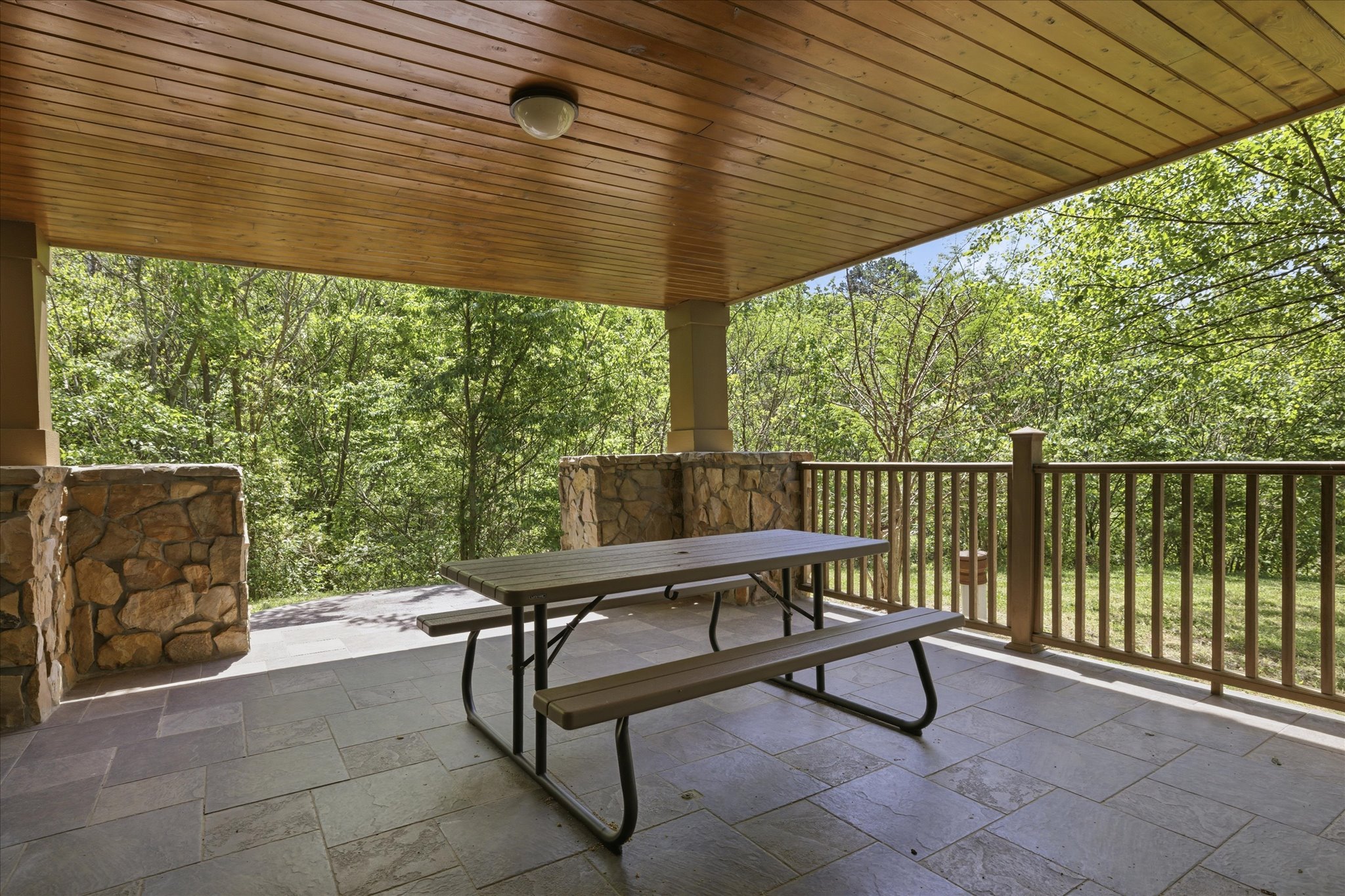 Gather on the covered porch with a picnic table ready for meals, conversation, or just unwinding while you take in the peaceful surroundings.