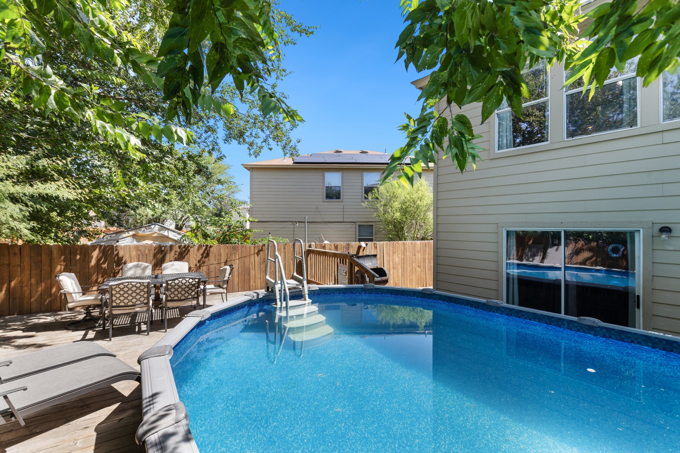 Above-ground pool and patio in a fully fenced private backyard. Swim, splash, and lounge in your own private outdoor space — one of the standout features of this Northeast San Antonio group rental.