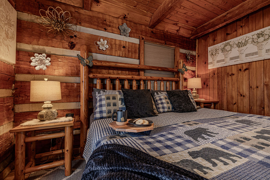  Drift off in this warmly lit bedroom with a handcrafted log bed and cabin decor.