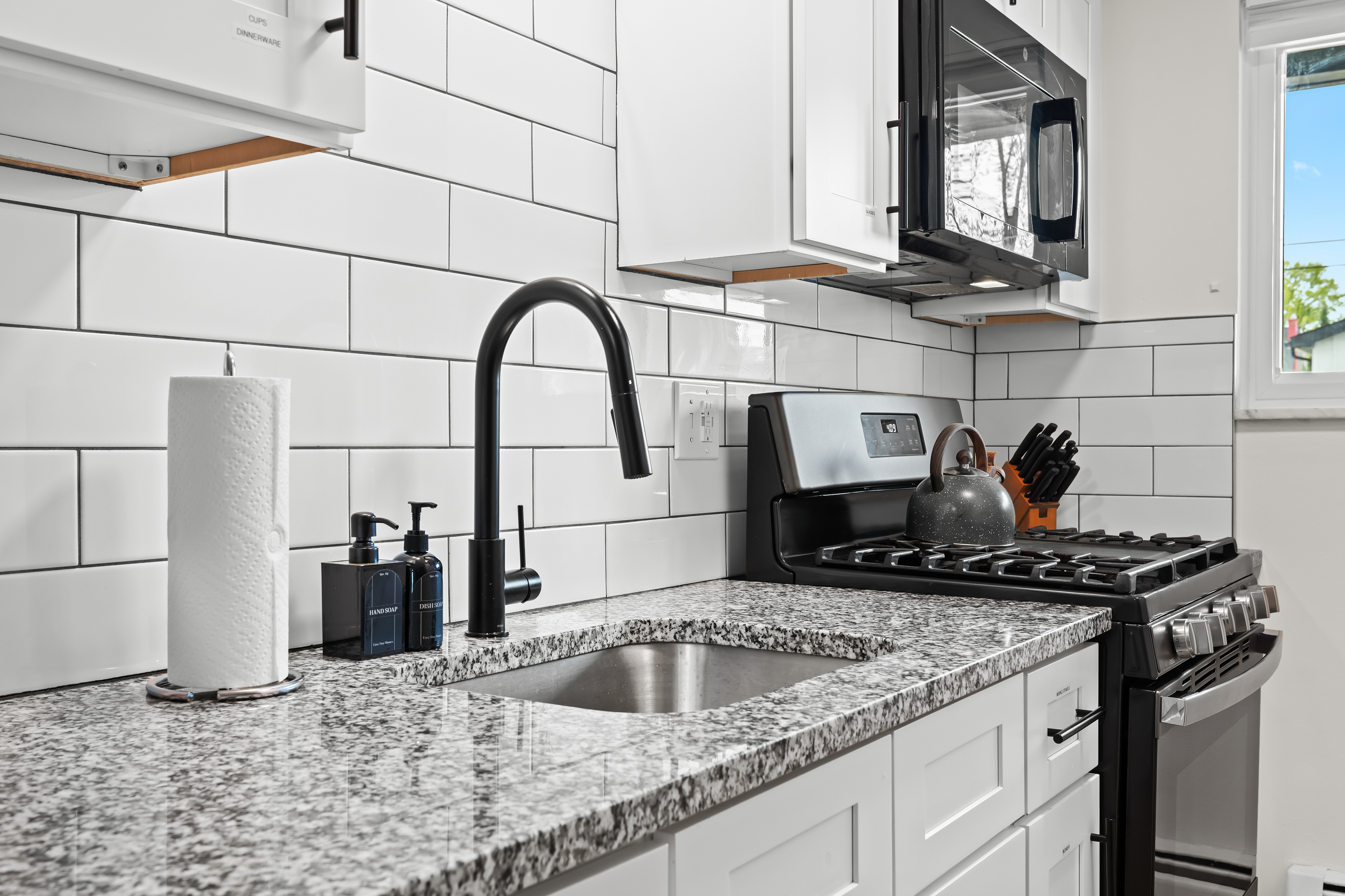 Modern kitchen with sleek finishes, granite countertops, and everything you need to cook at home.