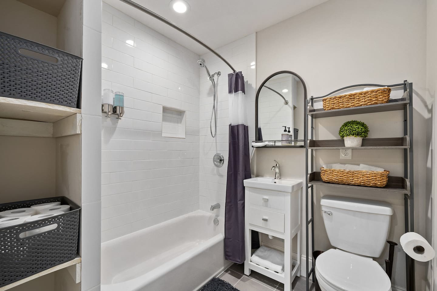 A spacious and refined bathroom equipped with a bathtub, fresh towels, and ample storage for a spa-like experience.
