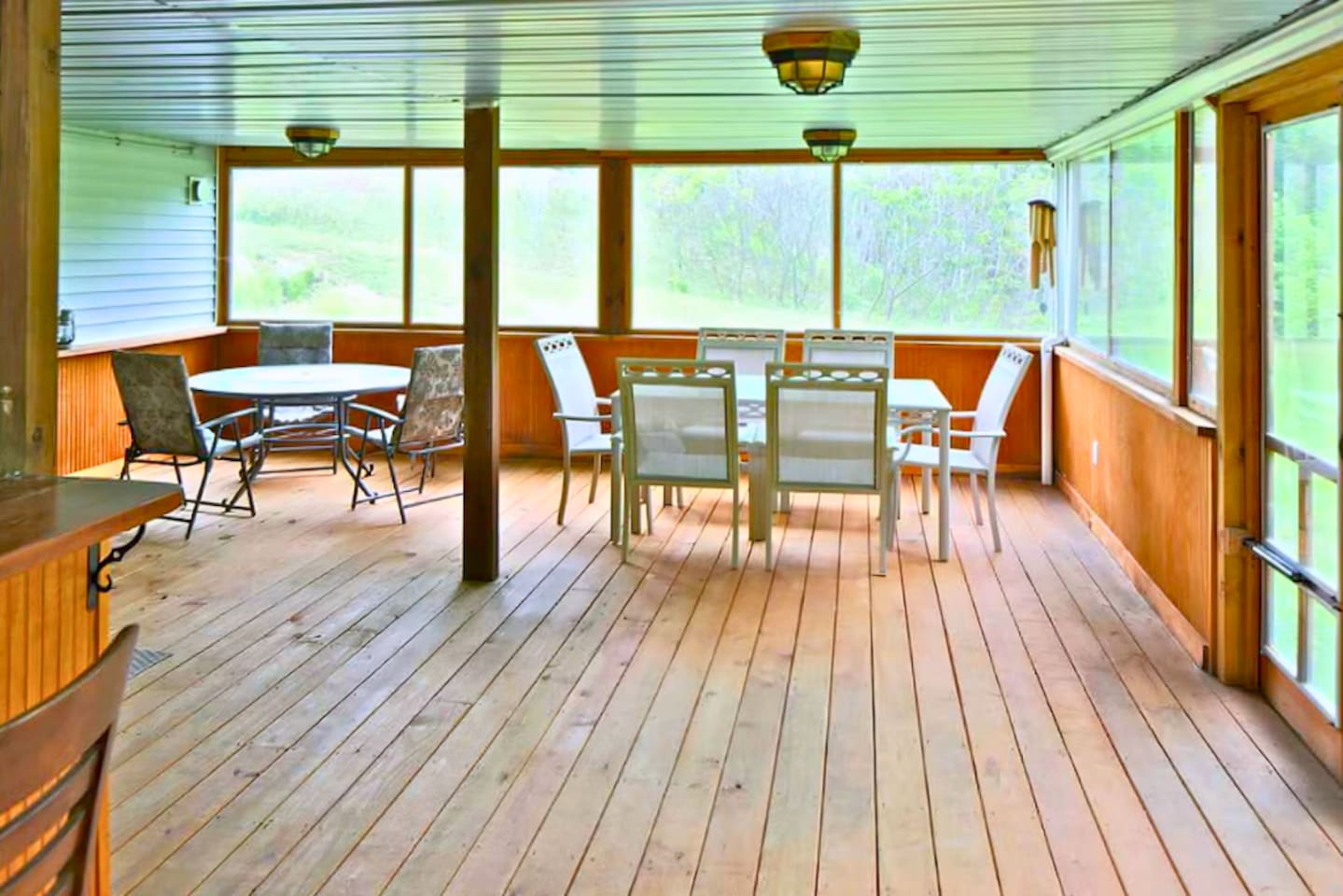 Lots of room for everyone in the enclosed porch near hot tub.