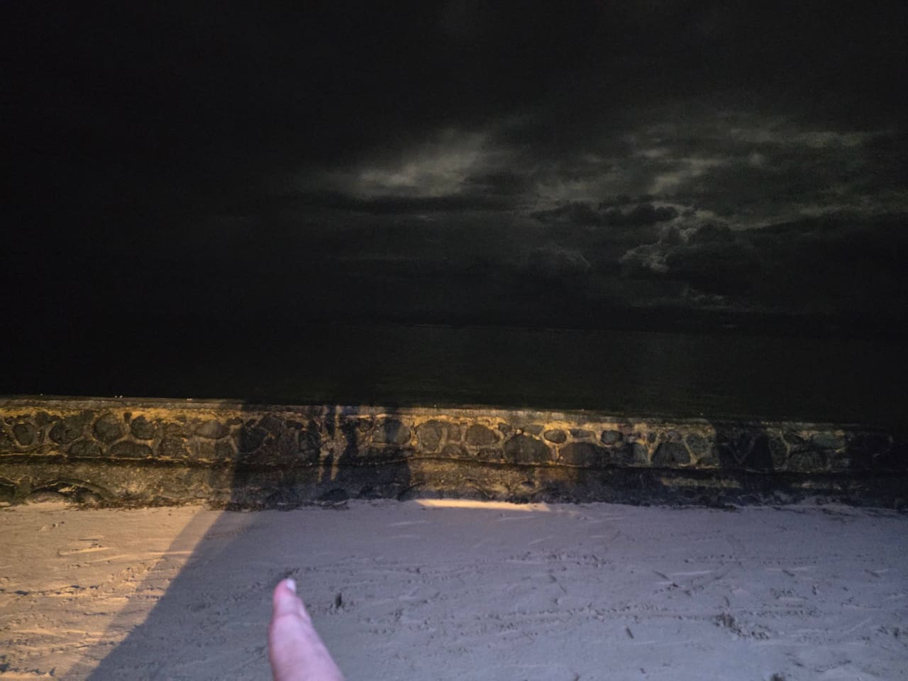 Ethereal Moonrise along with beautiful storm clouds in the ocean. 