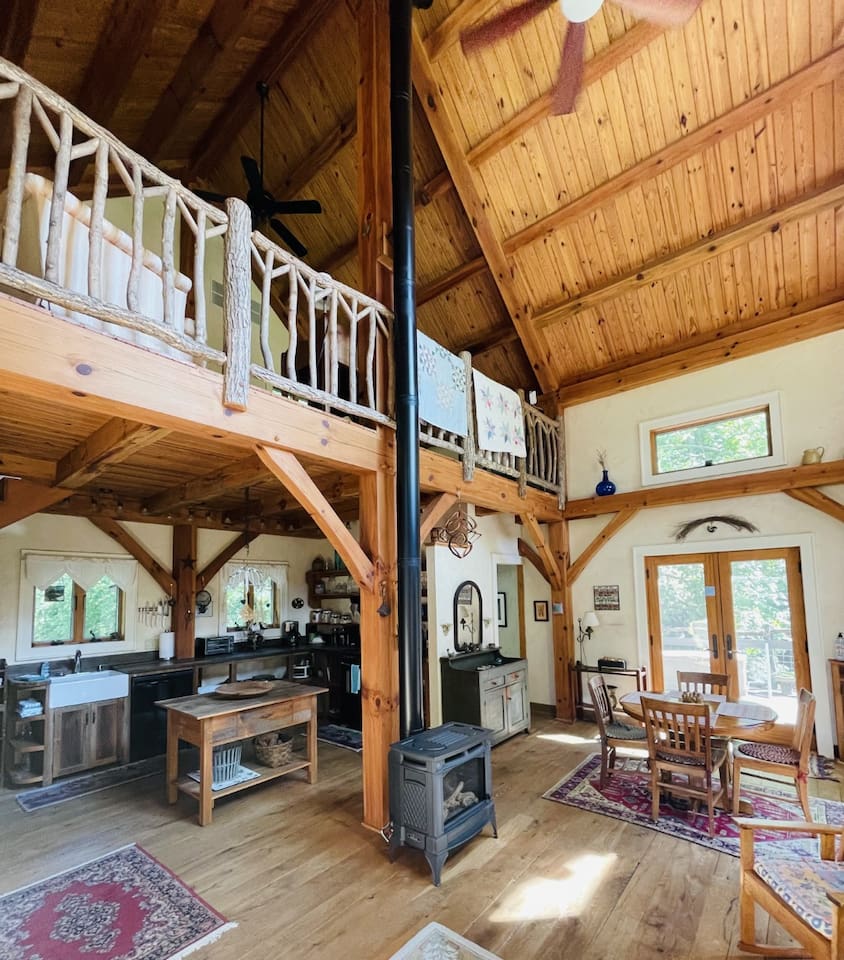 View of kitchen and dining from the comfy living room, complete with propane burning fire place