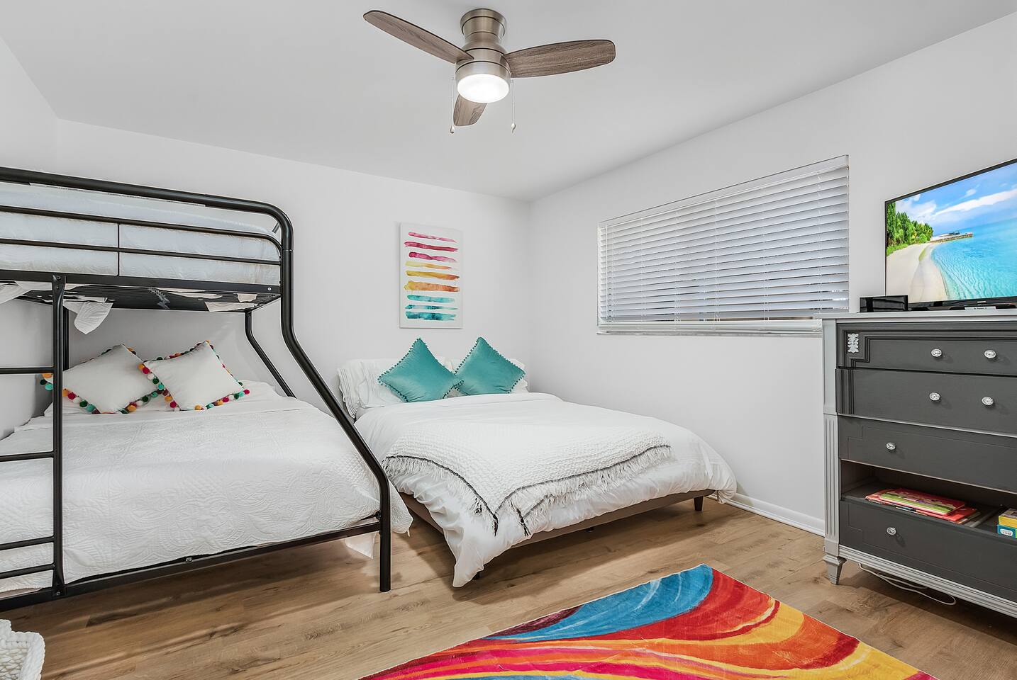 Perfect for families, the 2nd Guest bedroom includes a bunk bed, a queen-sized bed, and a TV for everyone's comfort and fun.