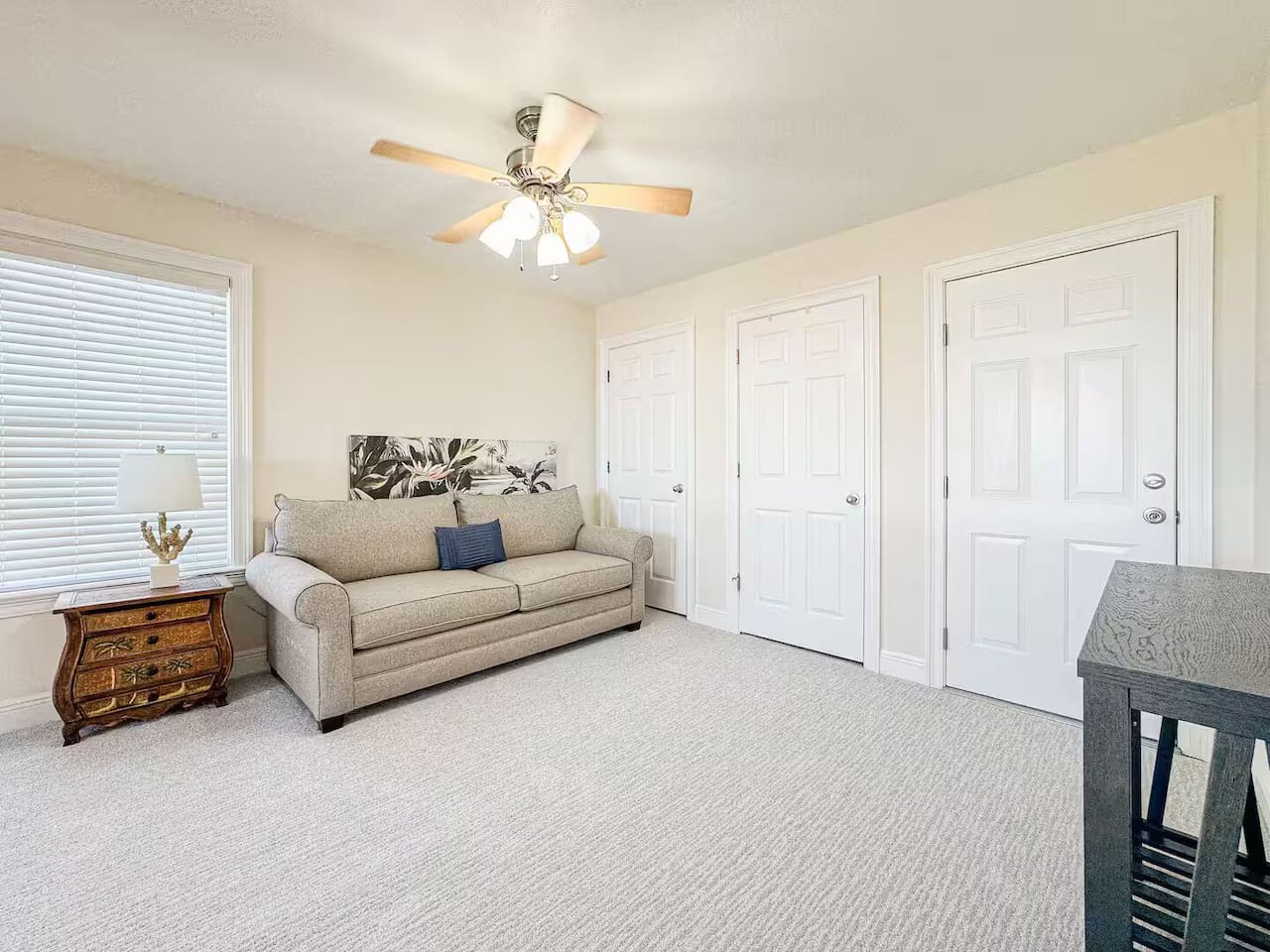 Comfortable bonus room with a sofa bed, ceiling fan, and plenty of space—ideal for extra guests or relaxing downtime.
