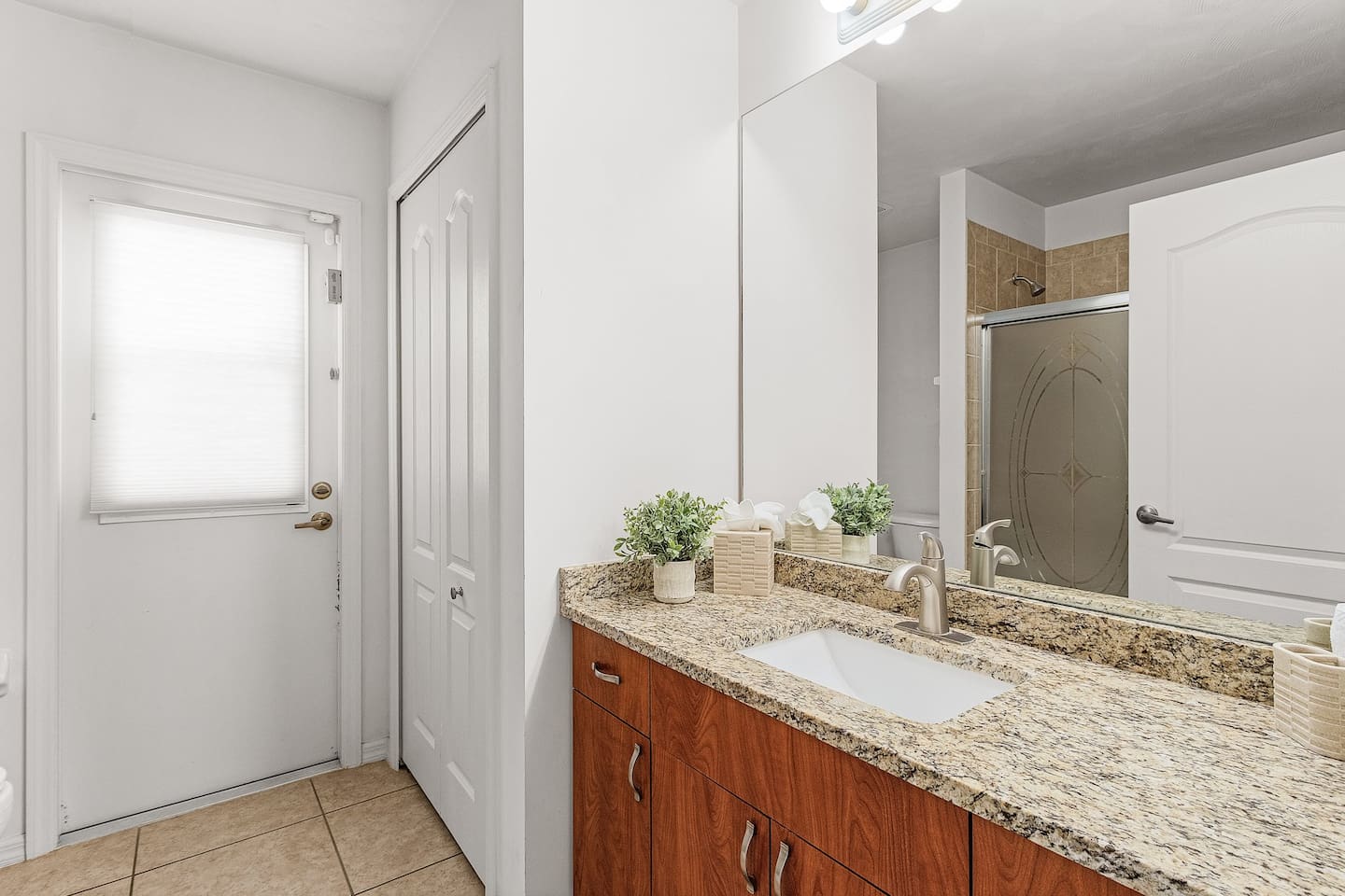 Convenient bathroom with shower/tub combo and direct access to the pool and lanai!