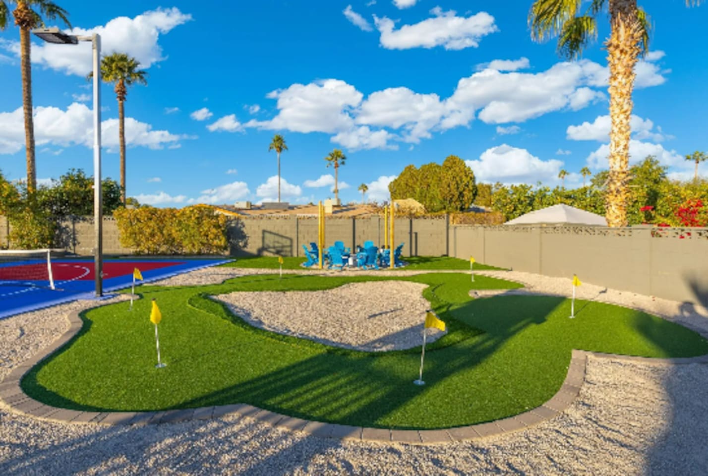 Multiple greens and flags make this putting course feel like its own mini golf getaway, shaded palms included.