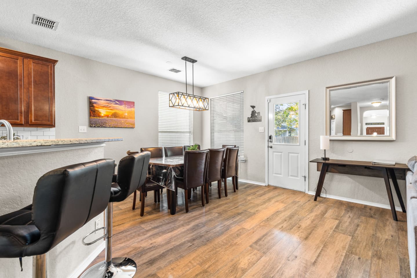 Open kitchen and dining space with seating for 8, providing a comfortable, connected layout ideal for multi-family travel and longer stays.