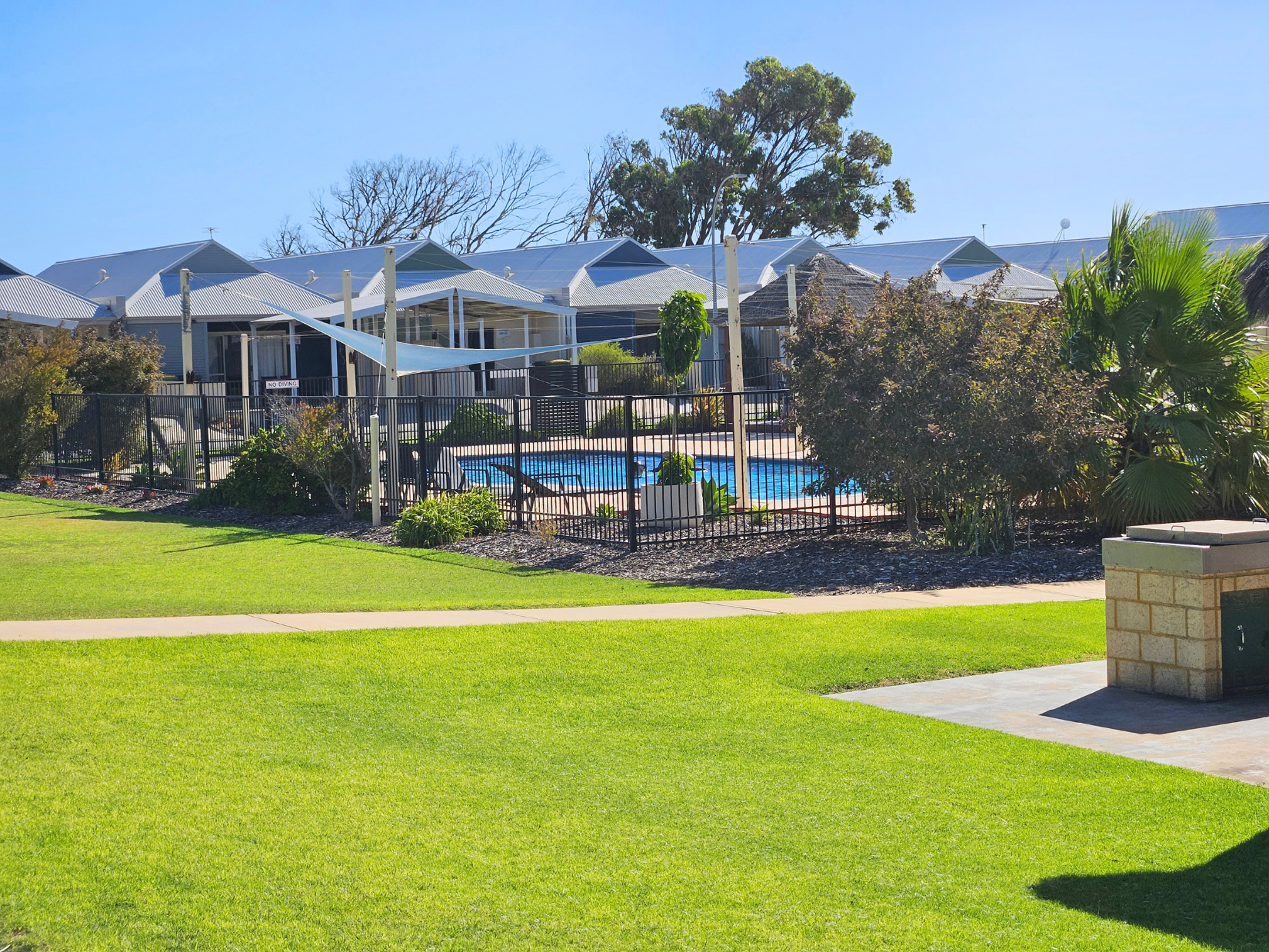 Lawna area with the complex but outside U45 with shared BBQ area
