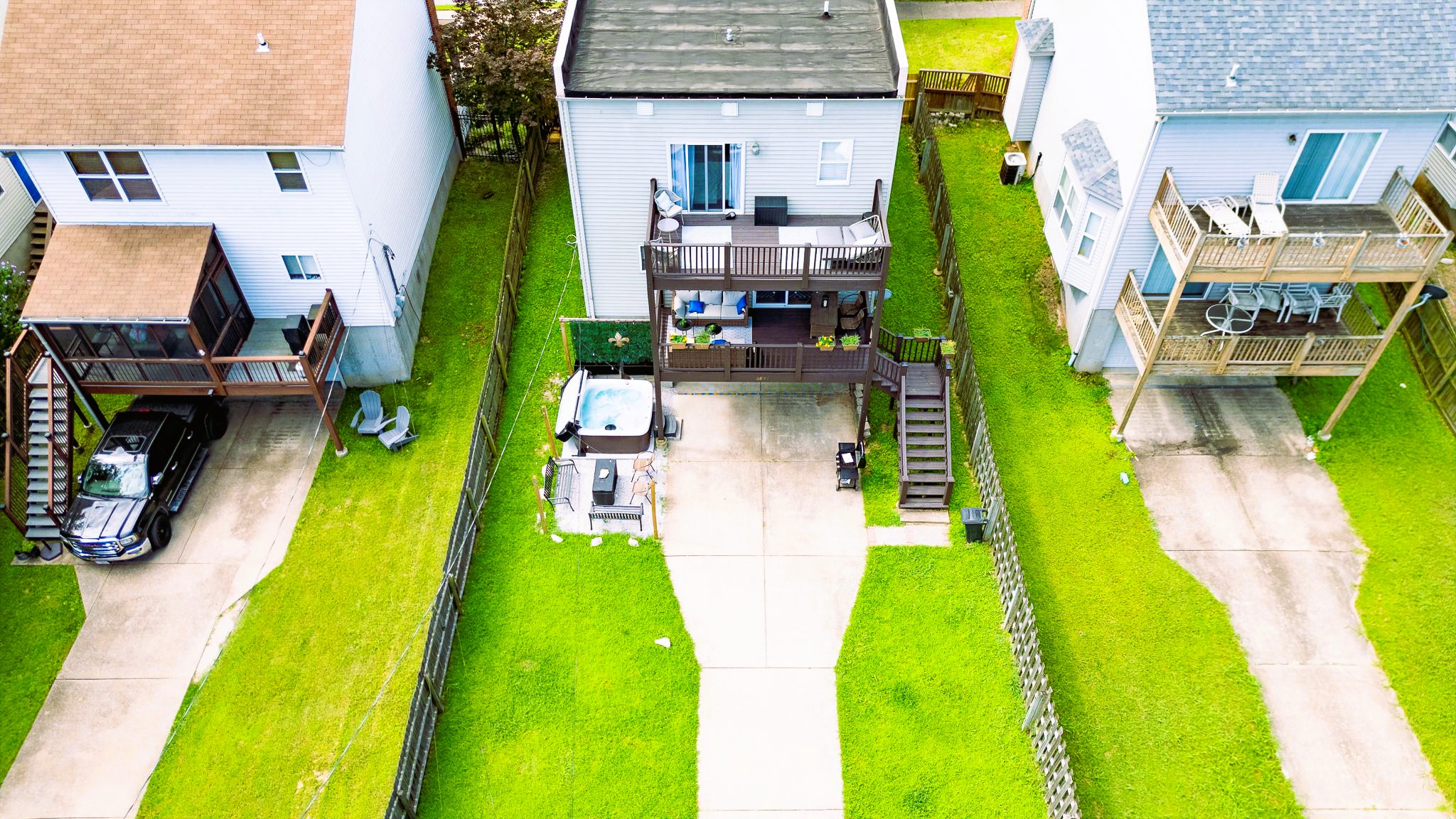 Private fenced backyard with hot tub, fire table, and gas grill. PLUS room for kids and dogs to play with secure gated parking — a major perk for a central St. Louis stay.