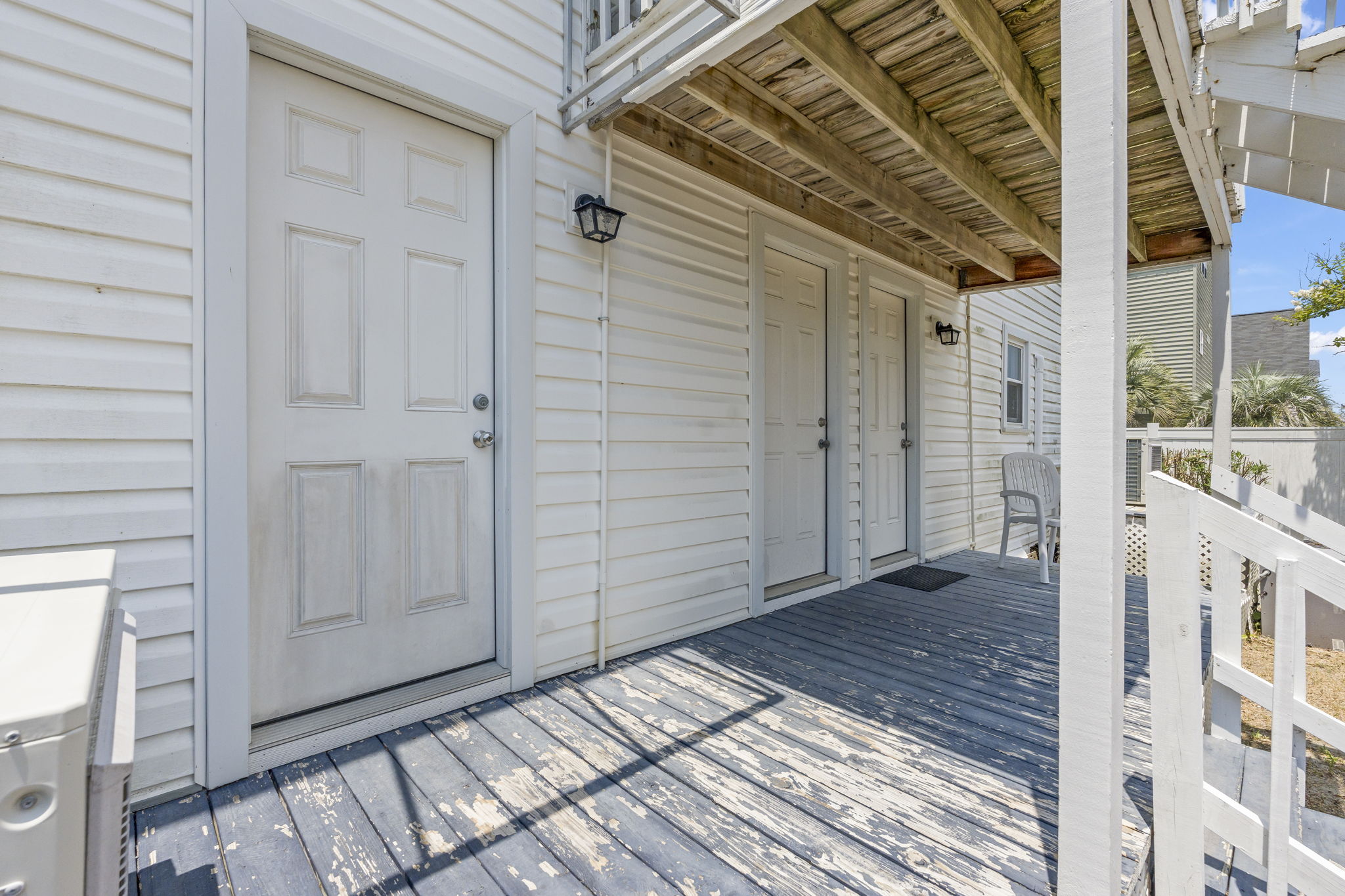 A small back porch connected to the Primary Bedroom that leads to the private backyard