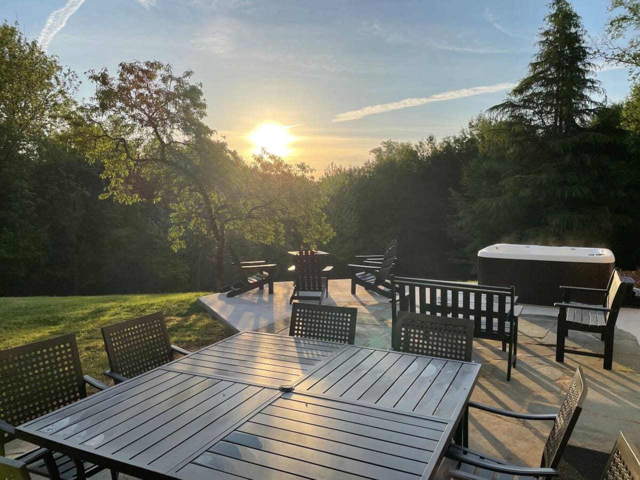 Outdoor dining, fire pit, and hot tub that is shared with any other guests staying in the private suites at Southern Guesthouse.