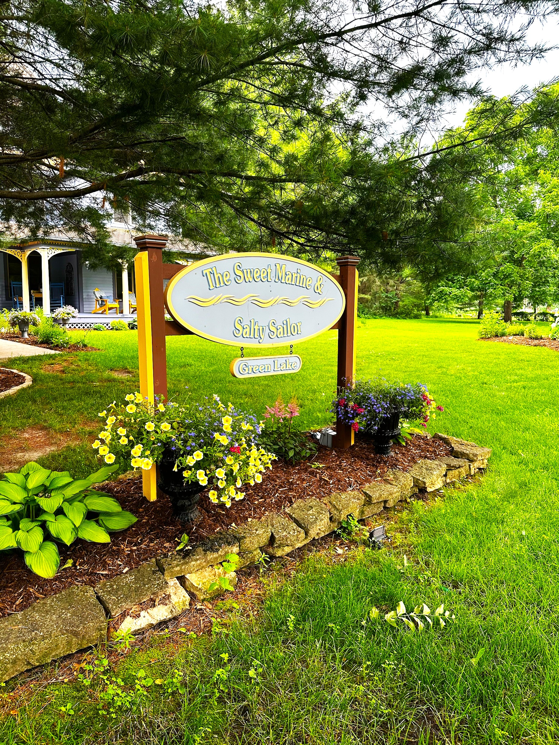 With flowers blooming and vibrant green grass, the home is surrounded by the fresh beauty of spring