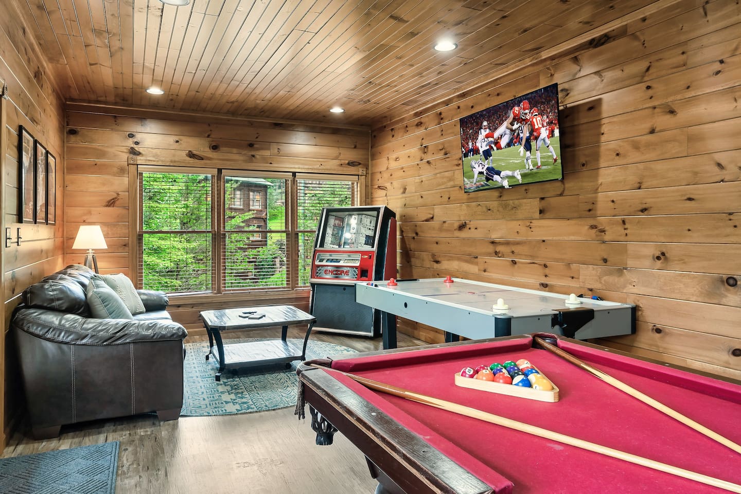Lounge in the rec room (lower level) with TV, pool table, air hockey, jukebox, pinball machine & more. Extra fridge/freezer in this room!