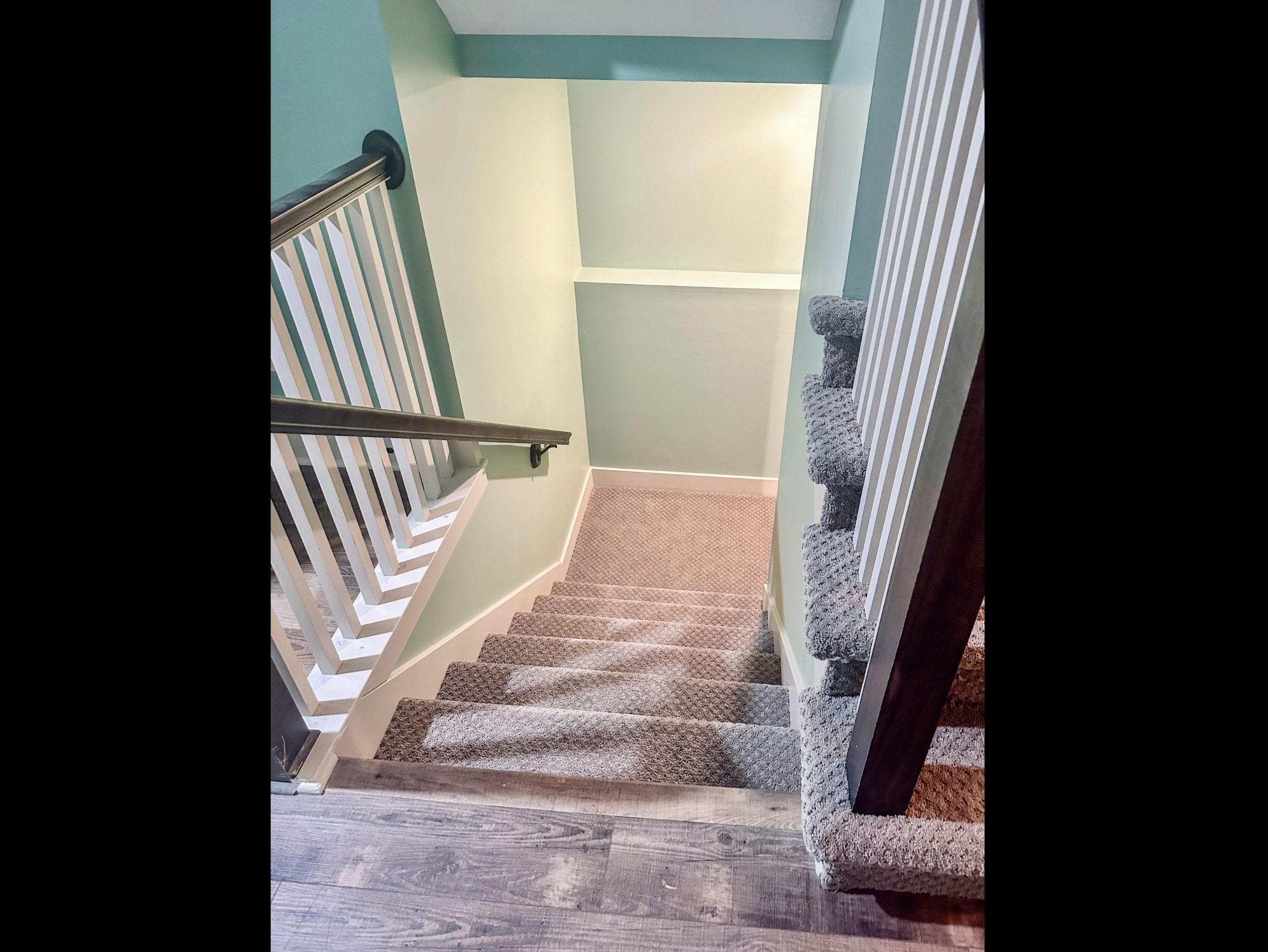 Main-level stair landing with access to the lower level, offering seamless flow between living spaces.