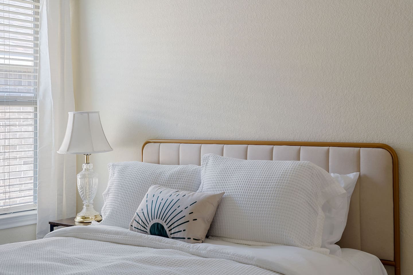 Explore a gorgeous bedroom that has a bedside lamp that adds to the pleasant ambiance.