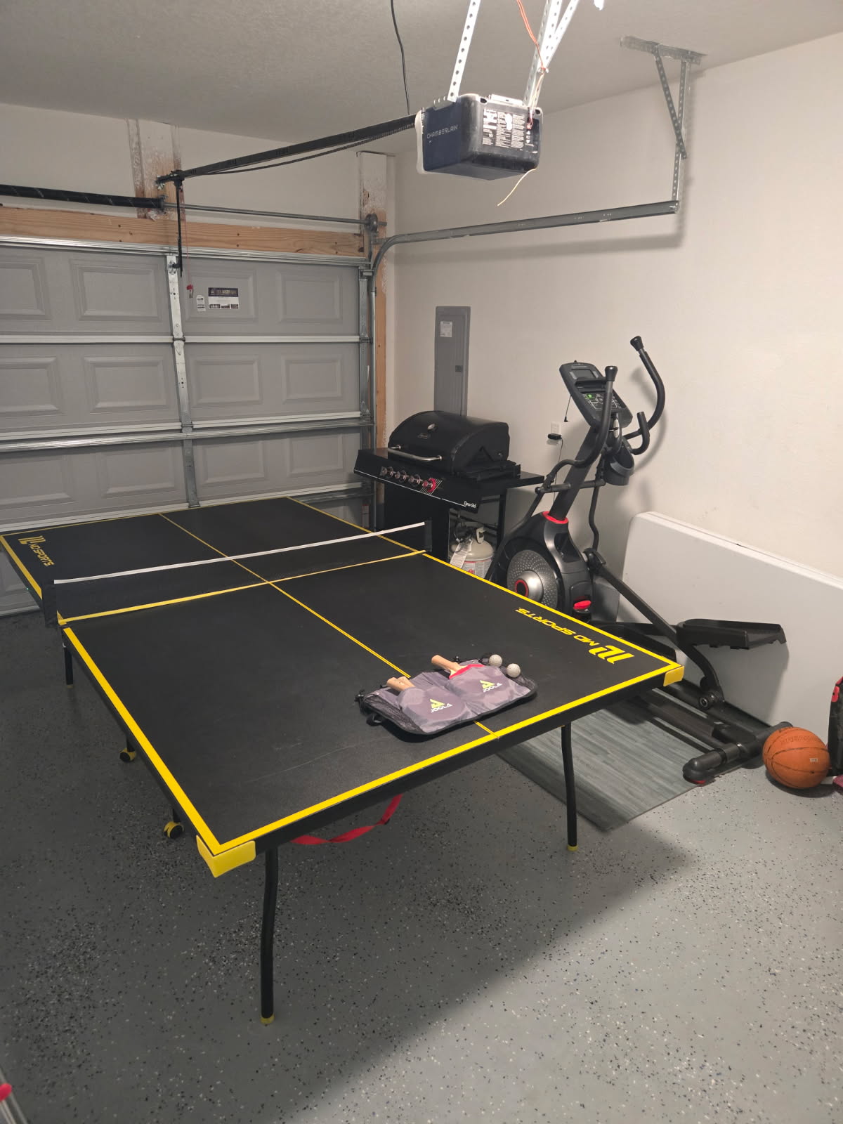 Full size ping pong table with paddles and balls, and propane grill, and eliptical machine.