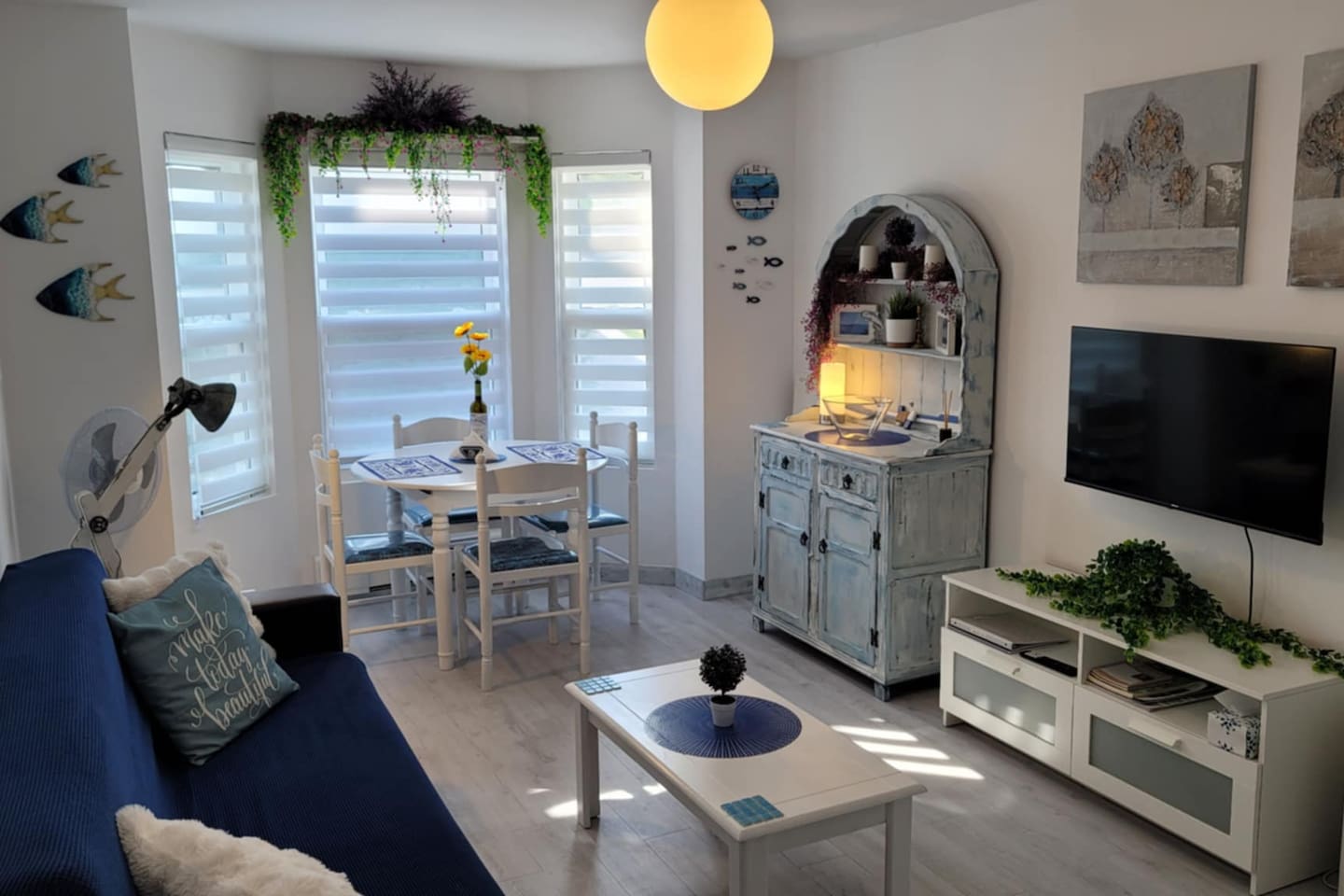 Living area with dining table for 4 guests, futon that folds in a single bed for 1 adult or 2 small children, and app TV.