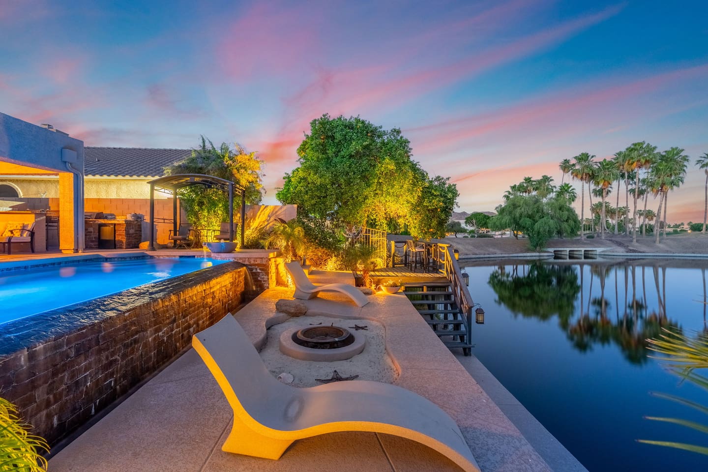 As dusk falls, the pool and lakeside terrace come alive with warm ambient lighting — a magical setting for evening drinks, conversation, or simply soaking in the view.