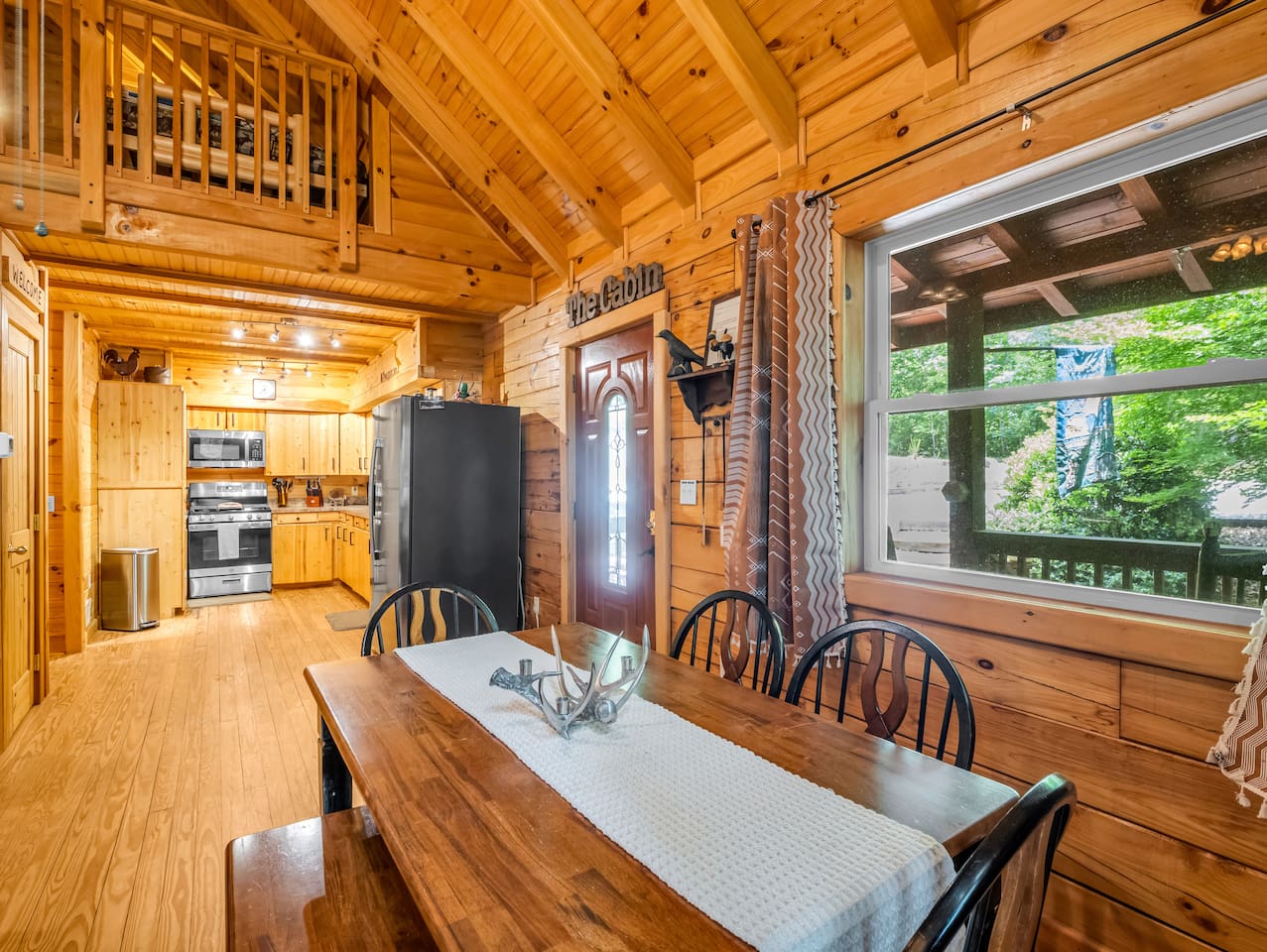 Gather around the dining table for meals, games, and conversation in this inviting open-concept space