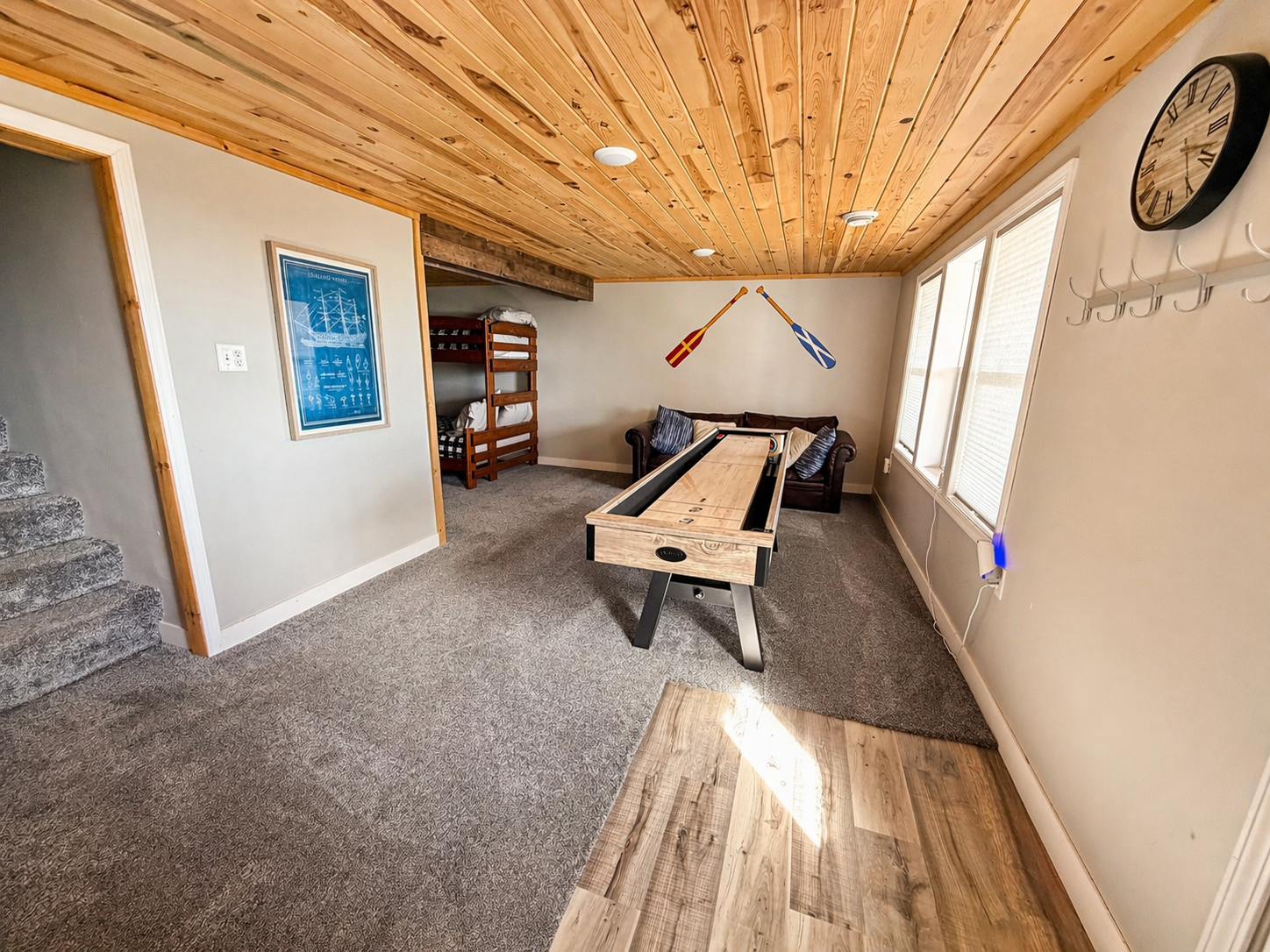 As you come downstairs, you'll find the shuffleboard ready for some fun.. The walkout door leads straight to the backyard, giving you easy access to the fire pit area for evenings outdoors.