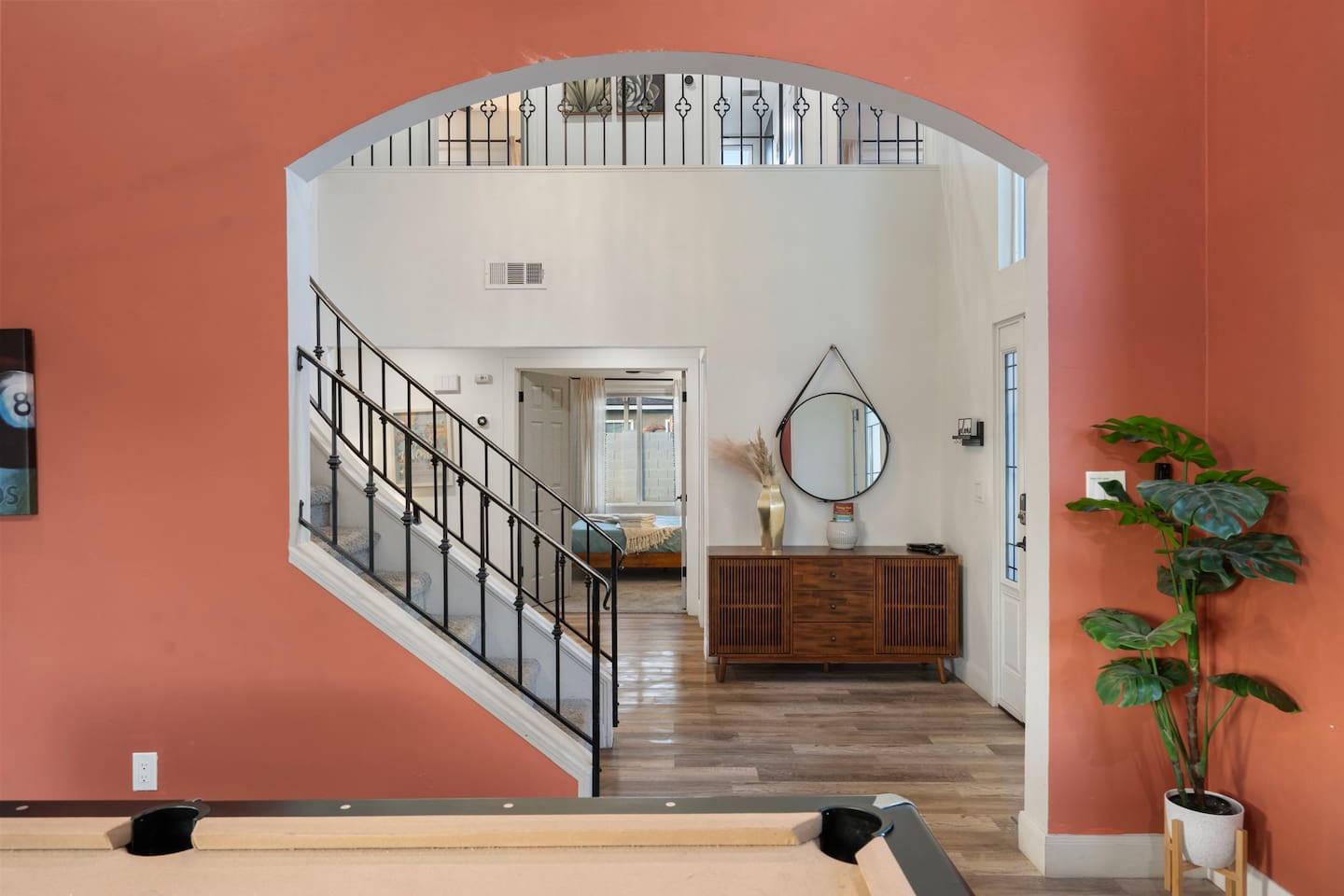 rand entry foyer with soaring ceilings, arched architectural details, and direct stair access.