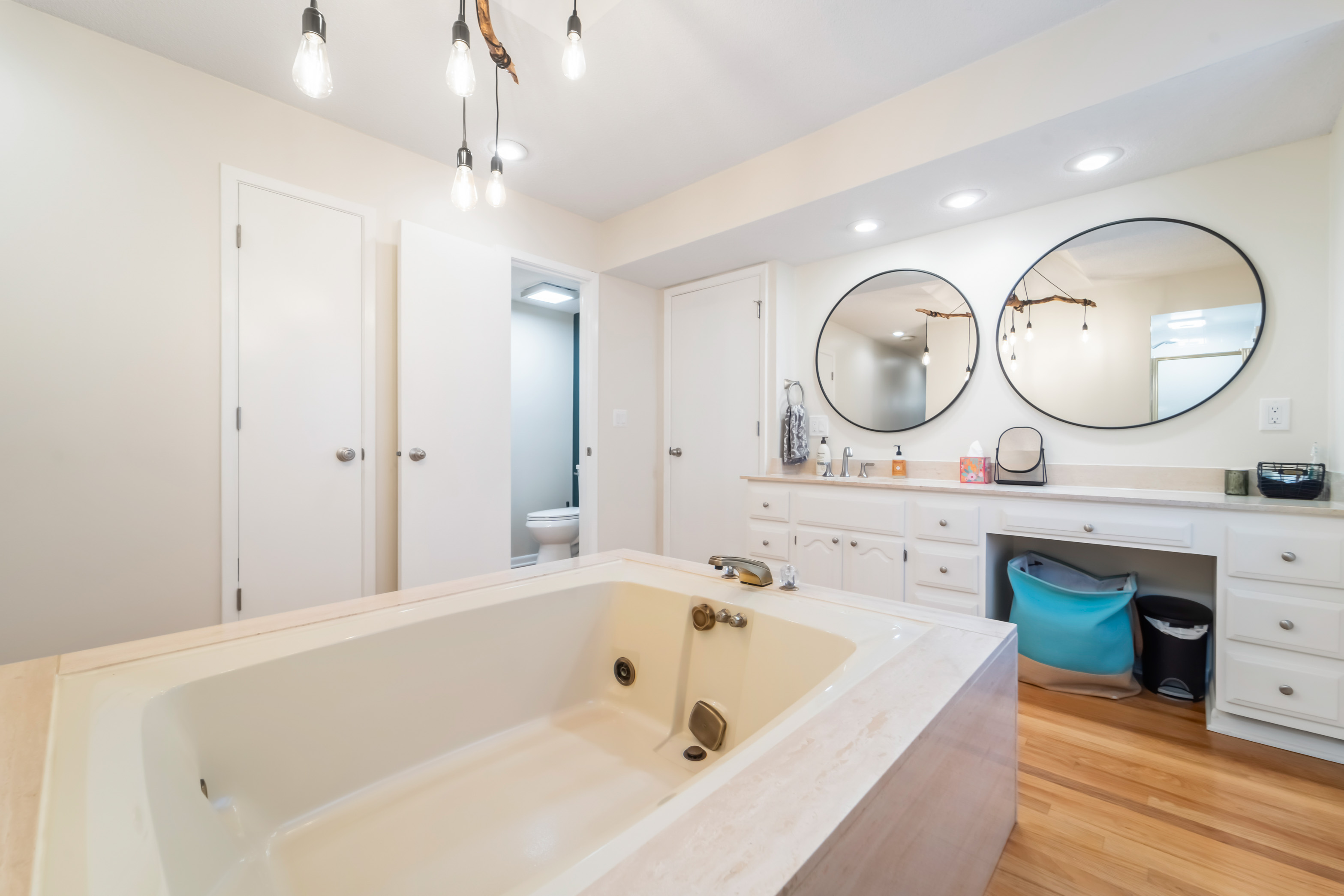 The ensuite bathroom has a large tub, toilet tucked away for privacy, and a large vanity for plenty of space to get ready.