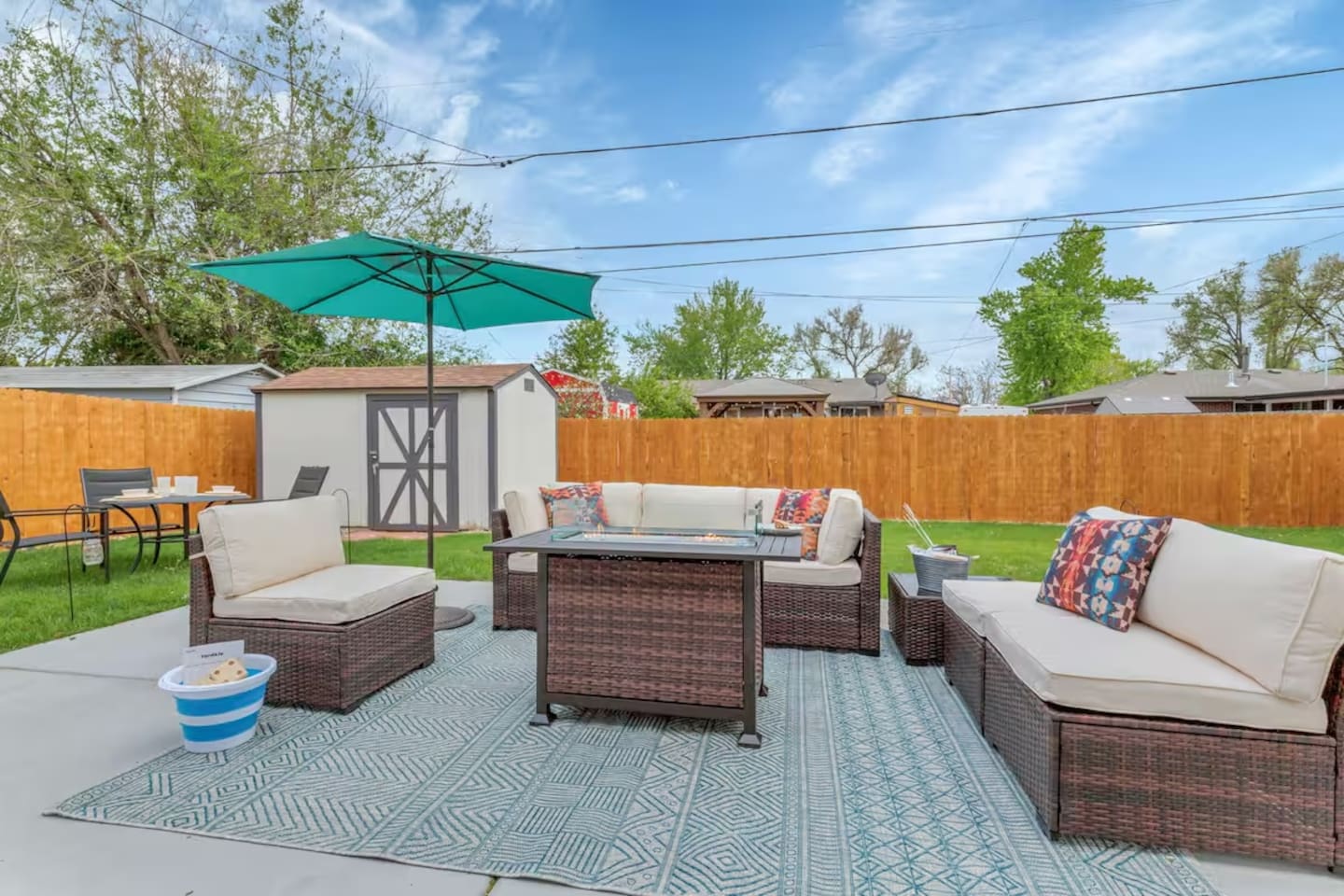 Fully fenced backyard with patio furniture, hot tub and fire pit.