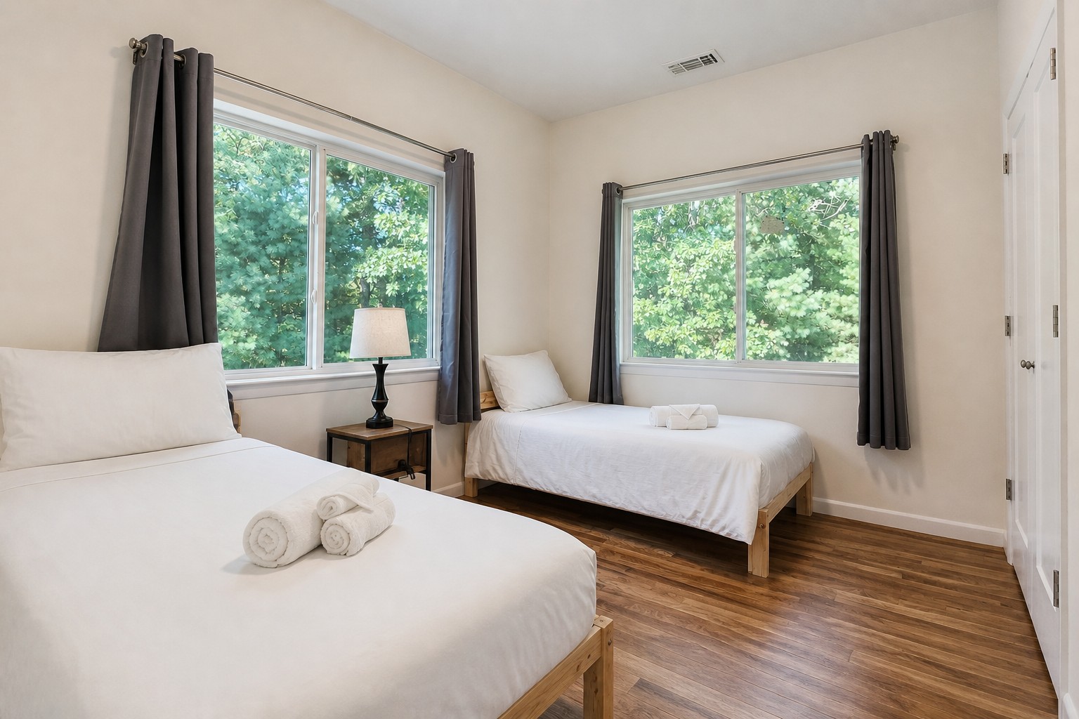 Second bedroom with two beds and corner windows