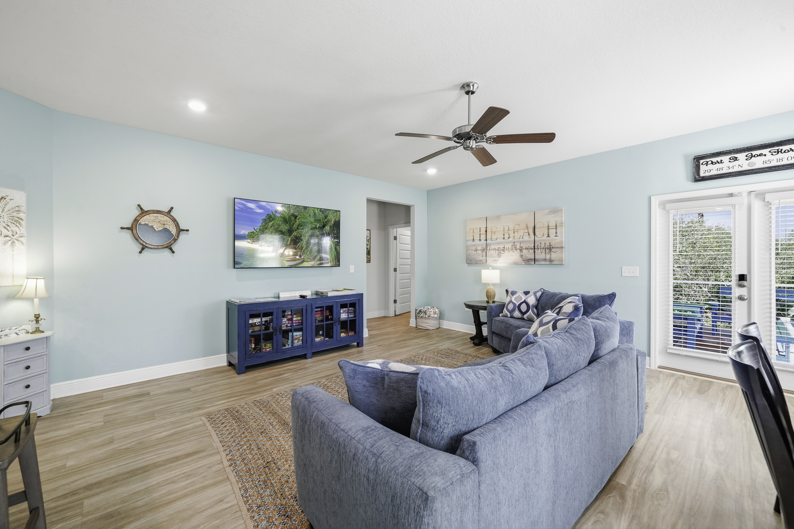 Relax in comfort with cozy seating, Smart TV, and a ceiling fan