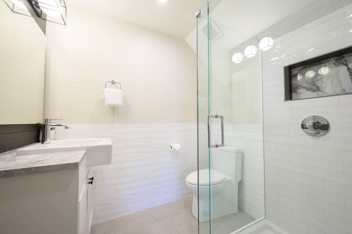 Ensuite Bathroom #3 features a bright and beautifully tiled shower complete with marble inset. 
