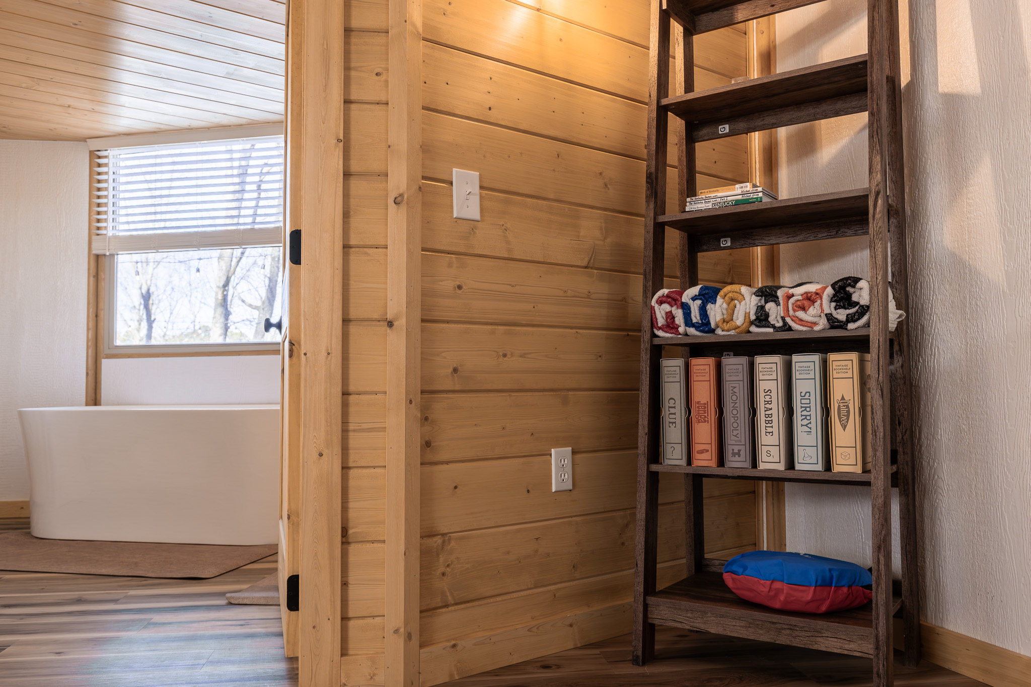 Games, books, and towels just outside the spa-style soaking tub.