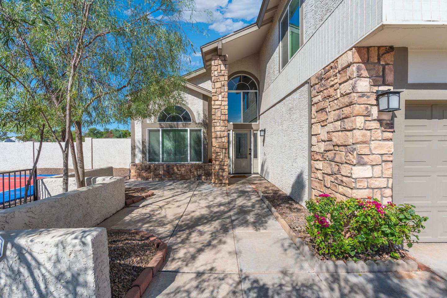 Stone accents and soaring windows set the tone the moment you arrive.