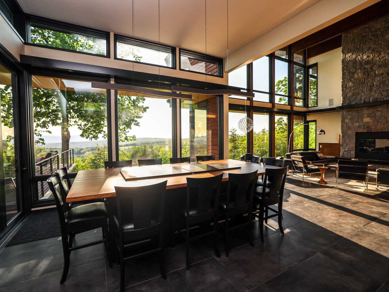 Great room dining table with fireplace and valley views &mdash; Sunset Falls