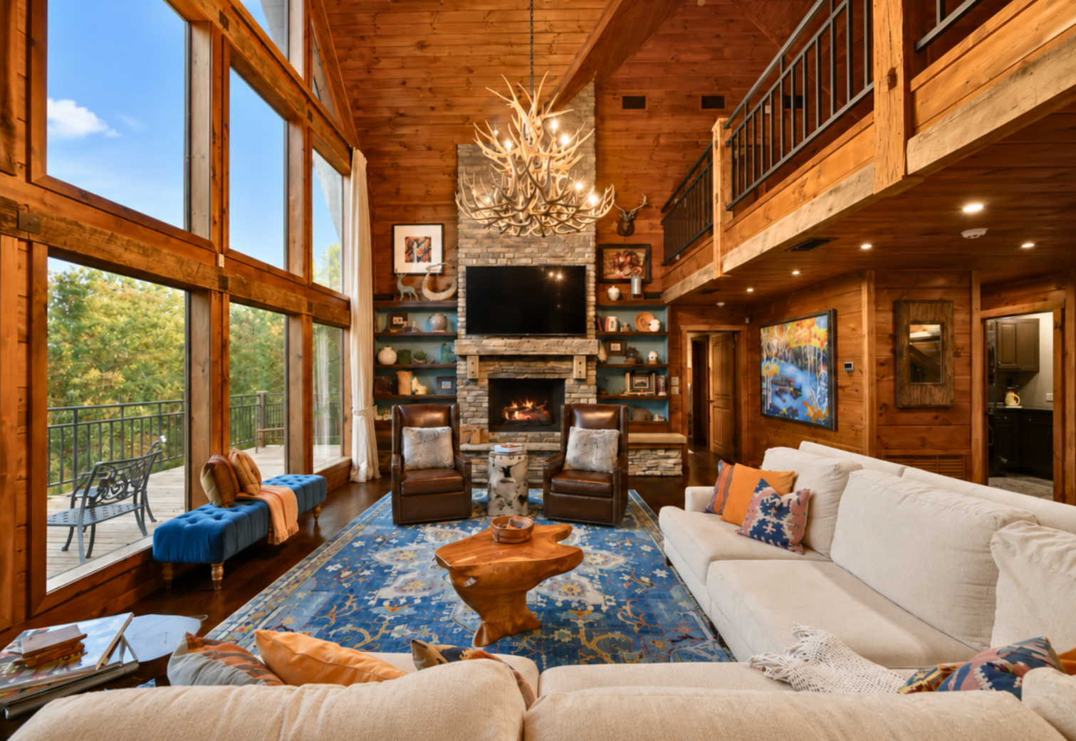 Unwind in a grand living room filled with natural light and cabin charm.