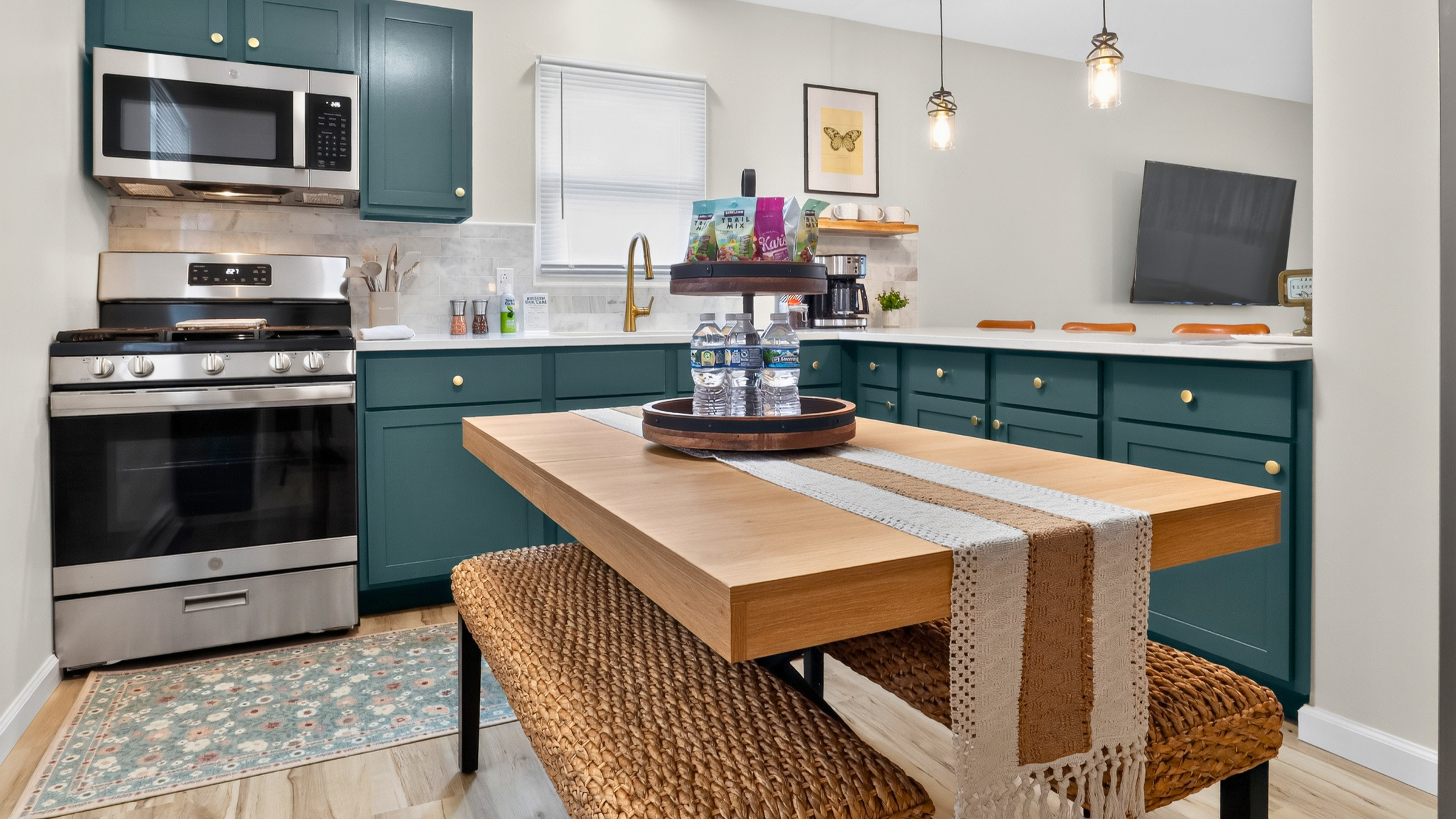 Beautiful stone finishes, stainless appliances, and island seating create a welcoming kitchen.