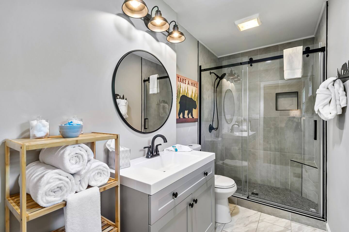 Unwind in style: Our newly renovated bathroom brings the serenity of the Smokies indoors. Plush towels, sleek shower, and bear-inspired decor await. Ready to book your mountain retreat?