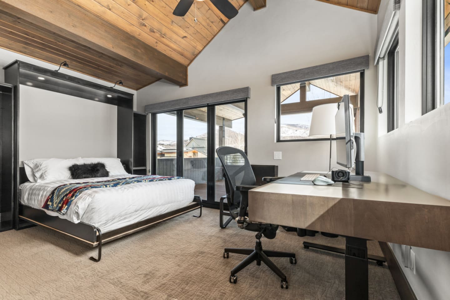 Upper Level Ensuite Bedroom 4 – Currently set up as an office with a Queen Murphy Bed & Private Deck 