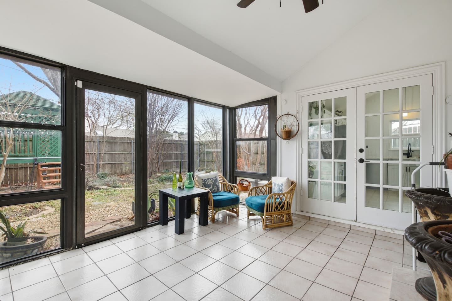 Spacious sunroom lounge with garden views, comfortable seating, and indoor-outdoor feel.