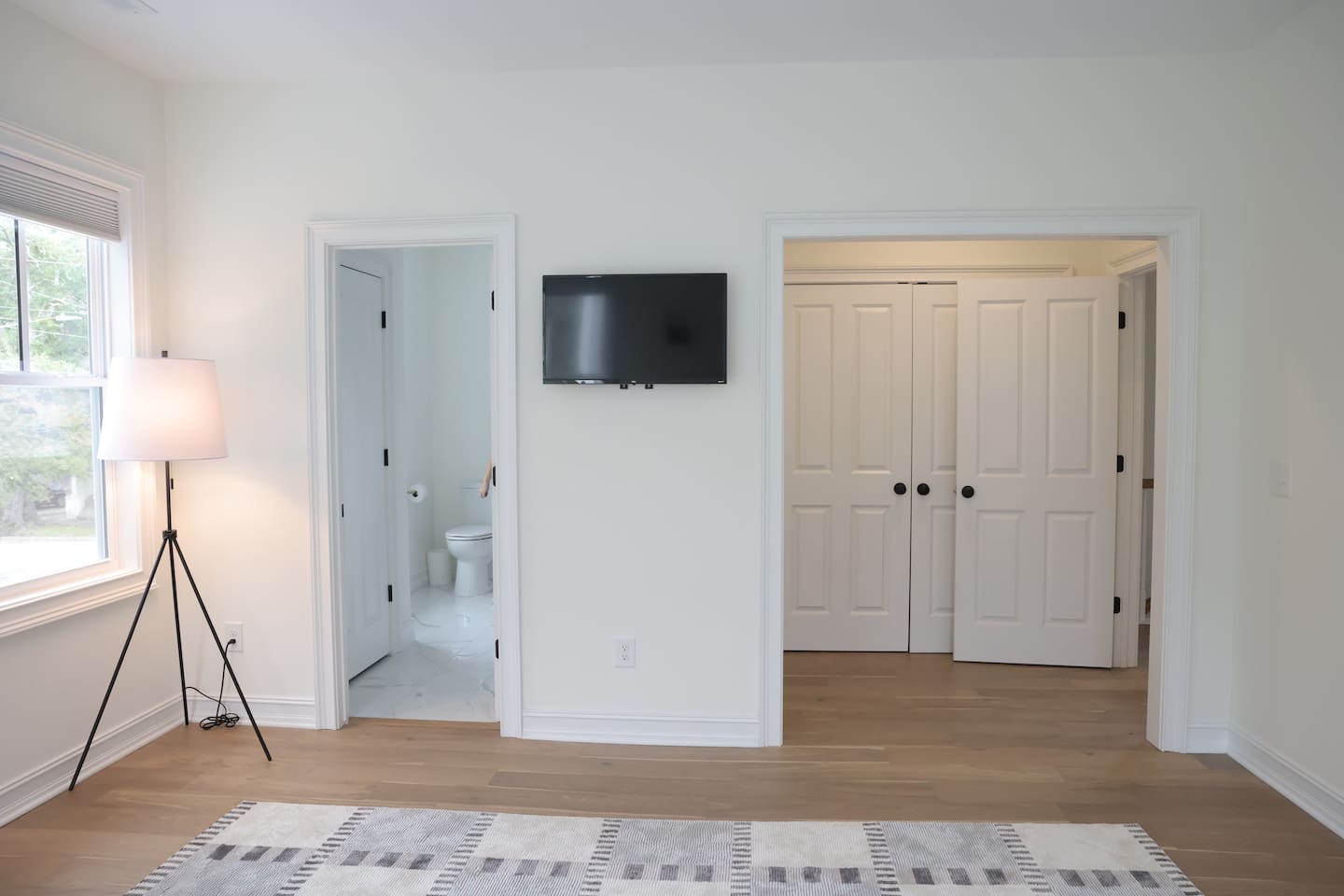 The spacious "sunrider room" features two queen beds, a spacious double-door closet, a full bath with a shower, smart TV and coastal photography. 